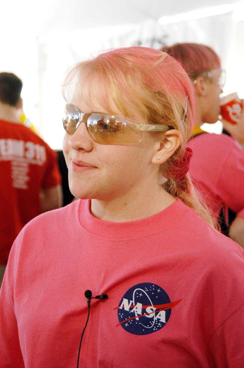 KENNEDY SPACE CENTER, FLA. -  Dressed for the part, a student on the KSC-sponsored “Pink” team waits during a break in the matches at the 2004 Florida Regional FIRST competition in the University of Central Florida Arena. The event hosted 41 teams from Canada, Brazil, Great Britain and the United States.  Among observers at the annual event were Center Director Jim Kennedy and Florida Gov. Jeb Bush, who spoke at the event luncheon.  FIRST is a nonprofit organization, For Inspiration and Recognition of Science and Technology, that sponsors the event pitting gladiator robots against each other in an athletic-style competition. The FIRST robotics competition is designed to provide students with a hands-on, inside look at engineering and other professional careers, pairing high school students with engineer mentors and corporations.