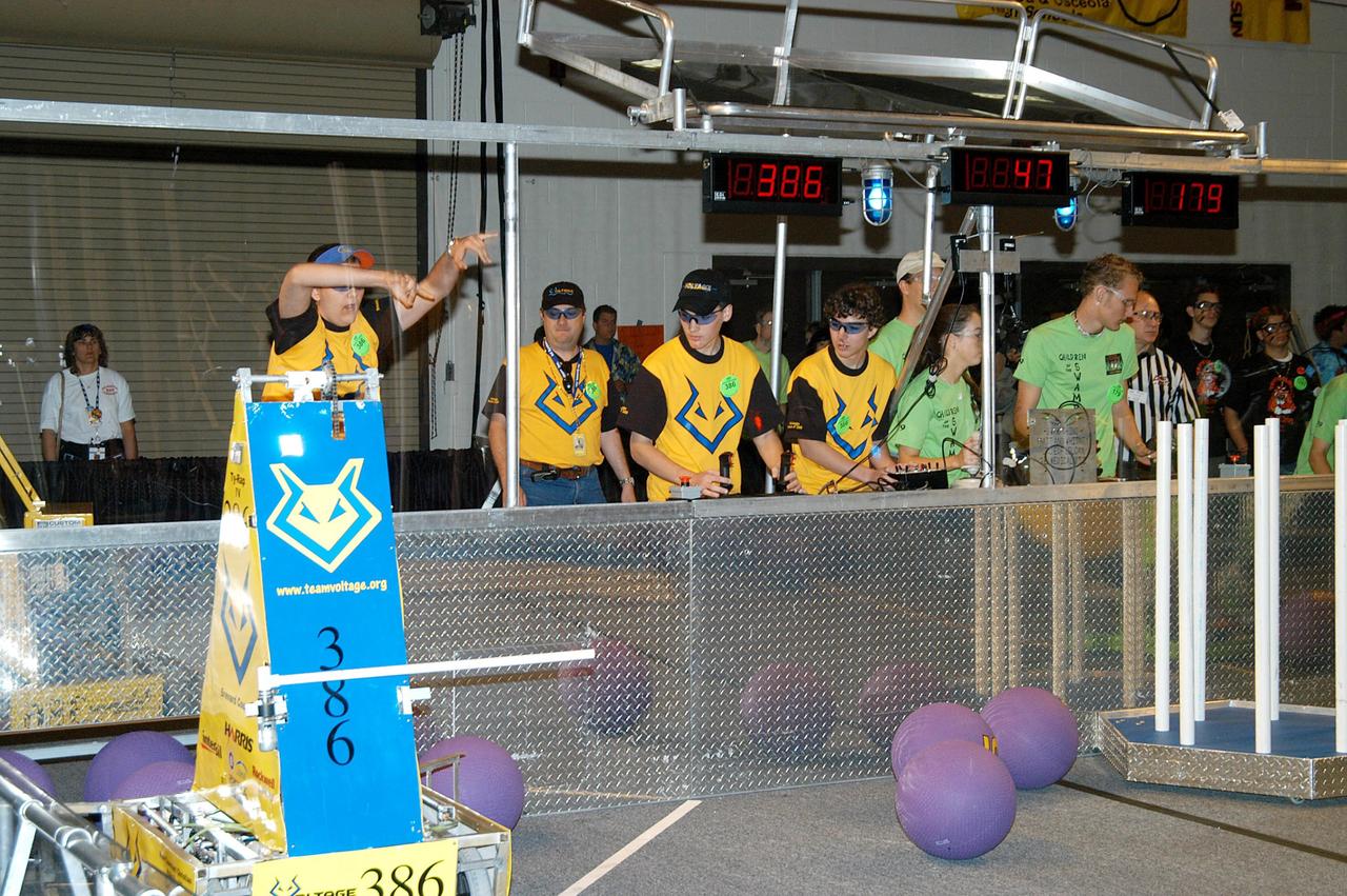 KENNEDY SPACE CENTER, FLA. -  Student teams maneuver their robots on the University of Central Florida Arena floor during the 2004 Florida Regional FIRST competition.  The event hosted 41 teams from Canada, Brazil, Great Britain and the United States.  Among observers at the annual event were Center Director Jim Kennedy and Florida Gov. Jeb Bush, who spoke at the event luncheon.  FIRST is a nonprofit organization, For Inspiration and Recognition of Science and Technology, that sponsors the event pitting gladiator robots against each other in an athletic-style competition. The FIRST robotics competition is designed to provide students with a hands-on, inside look at engineering and other professional careers, pairing high school students with engineer mentors and corporations.