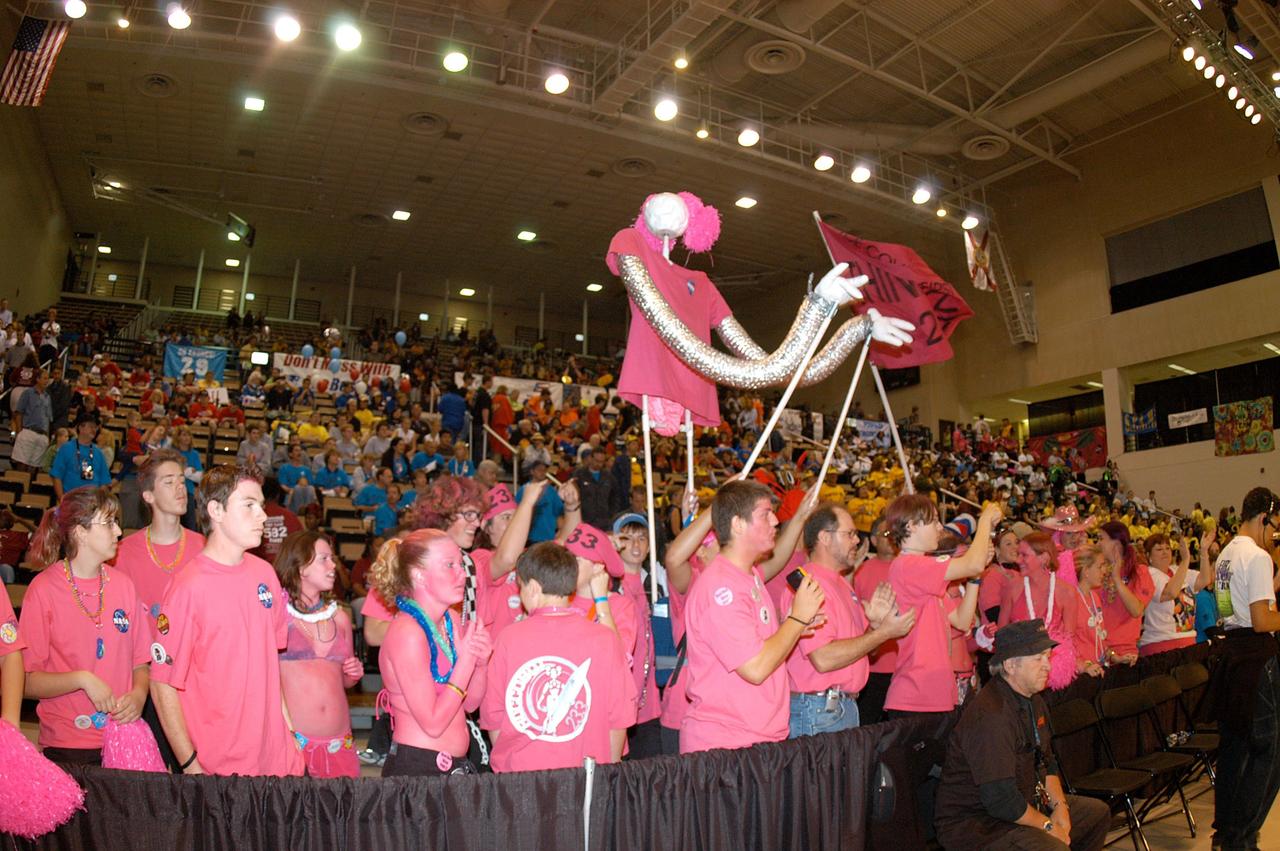 KENNEDY SPACE CENTER, FLA. -  Friends and families root for the KSC-sponsored “Pink” team during the 2004 Florida Regional FIRST competition in the University of Central Florida Arena.  The event hosted 41 teams from Canada, Brazil, Great Britain and the United States.  Among observers at the annual event were Center Director Jim Kennedy and Florida Gov. Jeb Bush, who spoke at the event luncheon.  FIRST is a nonprofit organization, For Inspiration and Recognition of Science and Technology, that sponsors the event pitting gladiator robots against each other in an athletic-style competition. The FIRST robotics competition is designed to provide students with a hands-on, inside look at engineering and other professional careers, pairing high school students with engineer mentors and corporations.