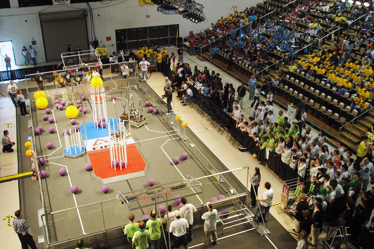 KENNEDY SPACE CENTER, FLA. -  Student teams maneuver their robots on the University of Central Florida Arena floor during the 2004 Florida Regional FIRST competition.  The event hosted 41 teams from Canada, Brazil, Great Britain and the United States.  Among observers at the annual event were Center Director Jim Kennedy and Florida Gov. Jeb Bush, who spoke at the event luncheon.  FIRST is a nonprofit organization, For Inspiration and Recognition of Science and Technology, that sponsors the event pitting gladiator robots against each other in an athletic-style competition. The FIRST robotics competition is designed to provide students with a hands-on, inside look at engineering and other professional careers, pairing high school students with engineer mentors and corporations.