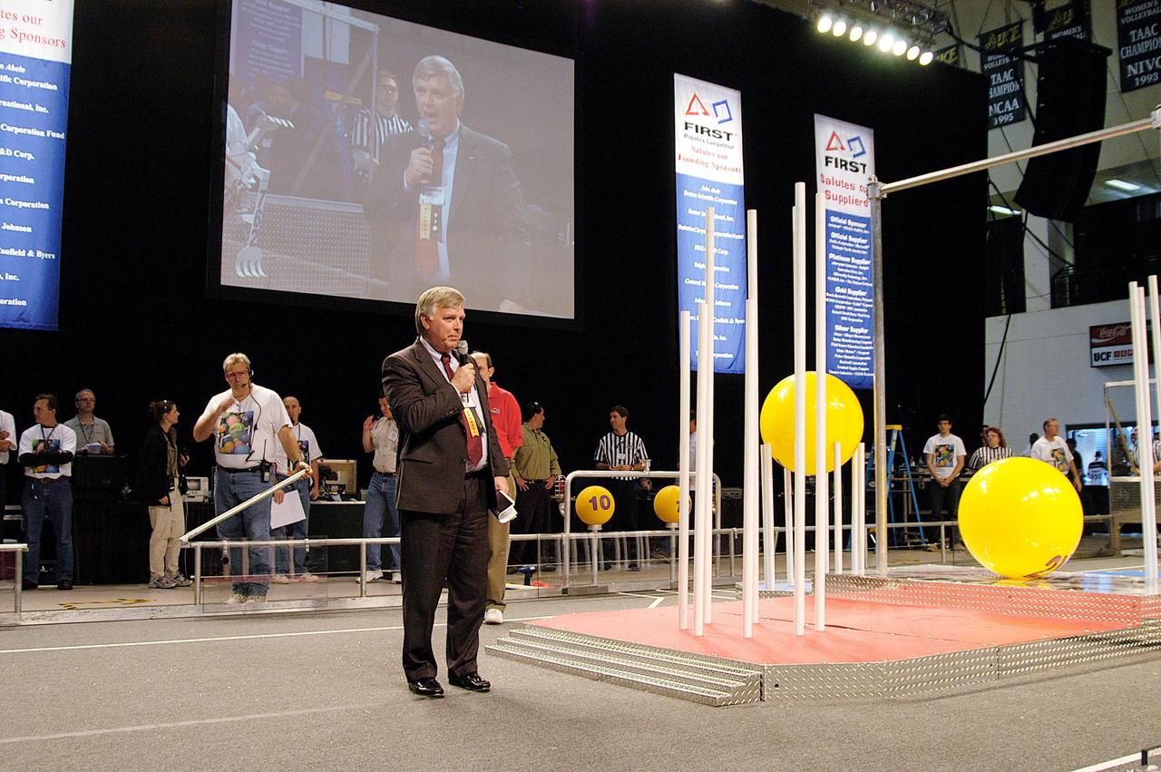 KENNEDY SPACE CENTER, FLA. -  Center Director Jim Kennedy speaks to attendees at the 2004 Florida Regional FIRST competition at the University of Central Florida.  The event hosted 41 teams from Canada, Brazil, Great Britain and the United States.  Florida Gov. Jeb Bush also spoke at the luncheon.  FIRST is a nonprofit organization, For Inspiration and Recognition of Science and Technology, that sponsors the event pitting gladiator robots against each other in an athletic-style competition. The FIRST robotics competition is designed to provide students with a hands-on, inside look at engineering and other professional careers, pairing high school students with engineer mentors and corporations.