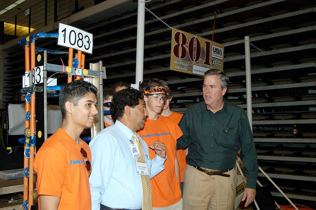 KENNEDY SPACE CENTER, FLA. -  Florida Gov. Jeb Bush talks to students competing with their robot at the 2004 Florida Regional FIRST competition, held at the University of Central Florida.  Bush and Center Director Jim Kennedy were among observers at the annual event that  hosted 41 teams from Canada, Brazil, Great Britain and the United States. FIRST is a nonprofit organization, For Inspiration and Recognition of Science and Technology, that sponsors the event pitting gladiator robots against each other in an athletic-style competition. The FIRST robotics competition is designed to provide students with a hands-on, inside look at engineering and other professional careers, pairing high school students with engineer mentors and corporations.