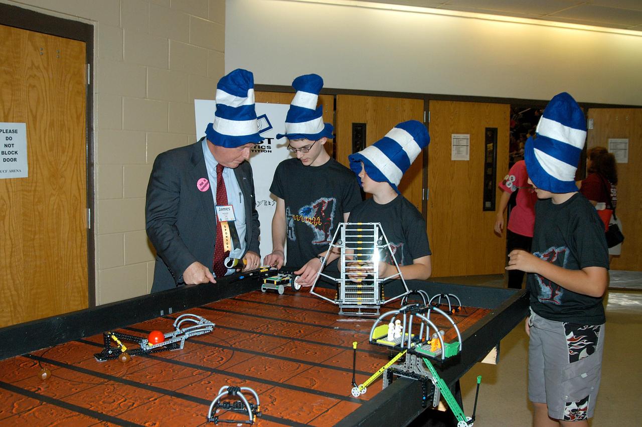 KENNEDY SPACE CENTER, FLA. -  While at the 2004 Florida Regional FIRST competition, held at the University of Central Florida, Center Director Jim Kennedy talks to participants in the FIRST LEGO™ League (FLL).  Considered the "little league" of the FIRST (For Inspiration and Recognition of Science and Technology) Robotics Competition, FLL is the result of a partnership between FIRST and the LEGO™ Company. FLL extends the FIRST concept of inspiring and celebrating science and technology to children aged 9 through 14, using real-world context and hands-on experimentation.  Young participants can build a robot and compete in a friendly, FIRST-style robotics event specially designed for their age group.