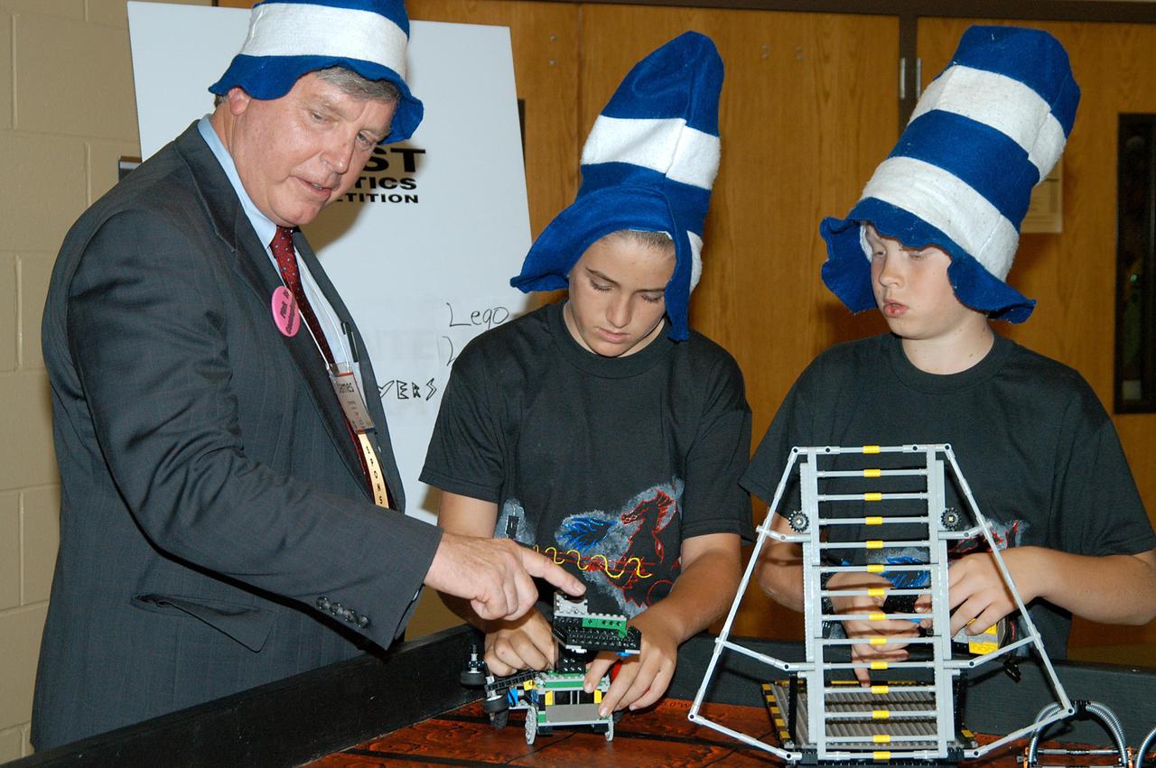 KENNEDY SPACE CENTER, FLA. -  While at the 2004 Florida Regional FIRST competition, held at the University of Central Florida, Center Director Jim Kennedy talks to participants in the FIRST LEGO™ League (FLL).  Considered the "little league" of the FIRST (For Inspiration and Recognition of Science and Technology) Robotics Competition, FLL is the result of a partnership between FIRST and the LEGO™ Company. FLL extends the FIRST concept of inspiring and celebrating science and technology to children aged 9 through 14, using real-world context and hands-on experimentation.  Young participants can build a robot and compete in a friendly, FIRST-style robotics event specially designed for their age group.