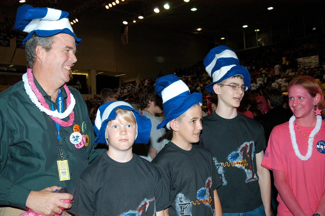 KENNEDY SPACE CENTER, FLA. -  During a break at the 2004 Florida Regional FIRST competition, held at the University of Central Florida, Florida Gov. Jeb Bush joins participants in the FIRST LEGO™ League (FLL).  Considered the "little league" of the FIRST (For Inspiration and Recognition of Science and Technology) Robotics Competition, FLL is the result of a partnership between FIRST and the LEGO™ Company. FLL extends the FIRST concept of inspiring and celebrating science and technology to children aged 9 through 14, using real-world context and hands-on experimentation.  Young participants can build a robot and compete in a friendly, FIRST-style robotics event specially designed for their age group.