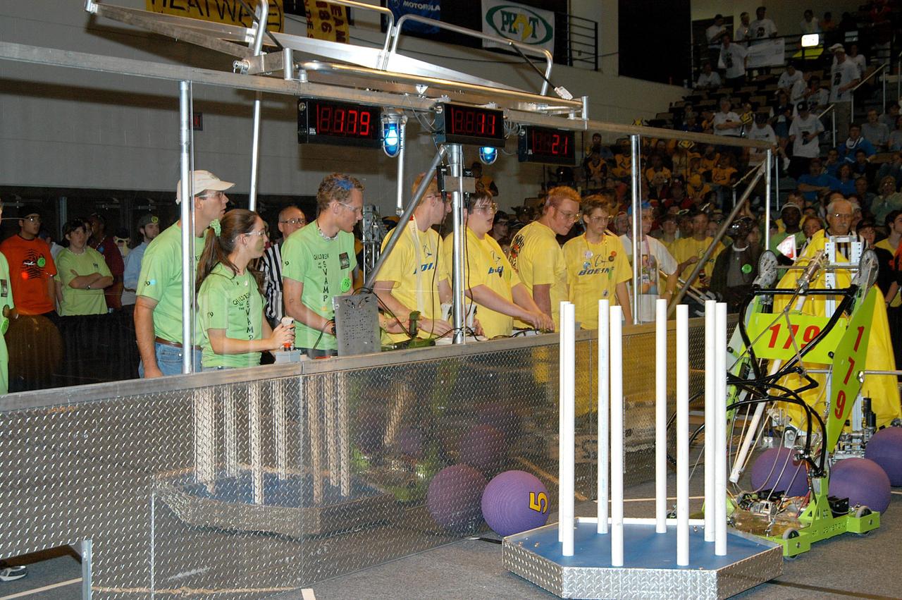 KENNEDY SPACE CENTER, FLA. - Two student teams vie for points during a match at the 2004 Florida Regional FIRST competition, held at the University of Central Florida. The annual event is hosting 41 teams from Canada, Brazil, Great Britain and the United States. FIRST is a nonprofit organization, For Inspiration and Recognition of Science and Technology, that sponsors the event pitting robots against each other in an athletic-style competition. The FIRST robotics competition is designed to provide students with a hands-on, inside look at engineering and other professional careers, pairing high school students with engineer mentors and corporations.