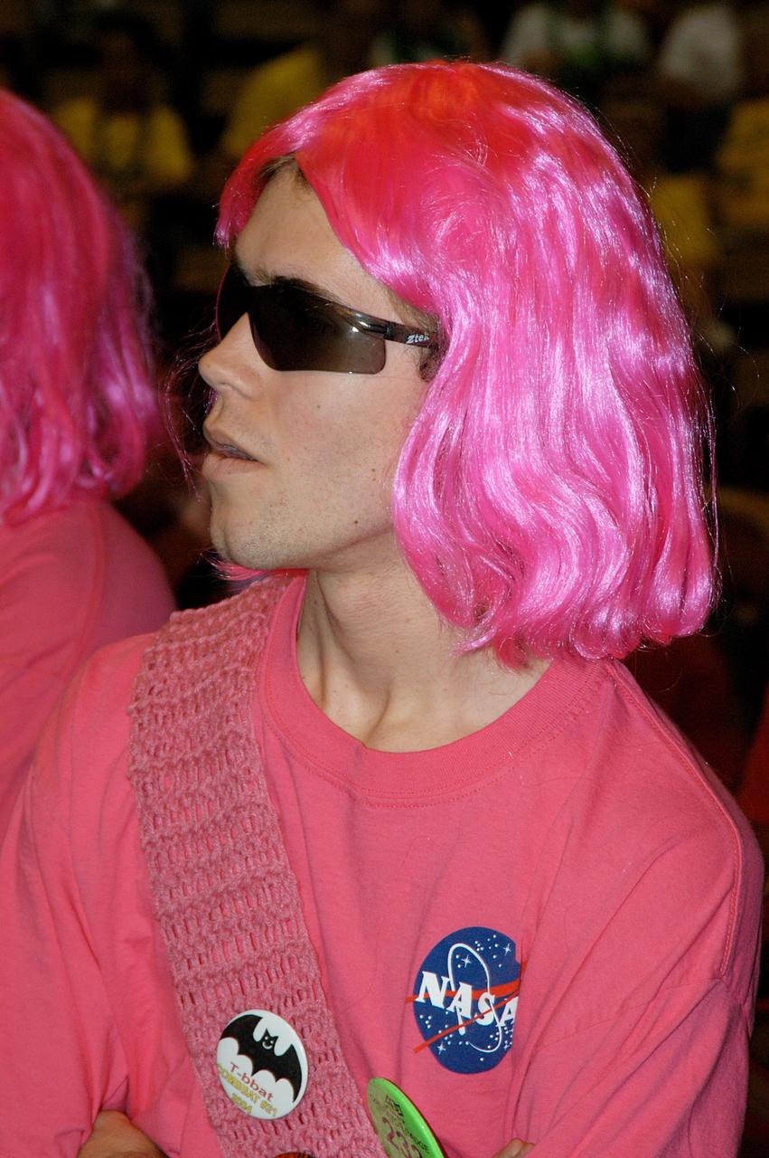 KENNEDY SPACE CENTER, FLA. -  A member of the KSC-sponsored “Pink” team watches a match during the 2004 Florida Regional FIRST competition, held at the University of Central Florida.  The annual event is hosting 41 teams from Canada, Brazil, Great Britain and the United States. FIRST is a nonprofit organization, For Inspiration and Recognition of Science and Technology, that sponsors the event pitting  robots against each other in an athletic-style competition. The FIRST robotics competition is designed to provide students with a hands-on, inside look at engineering and other professional careers, pairing high school students with engineer mentors and corporations.