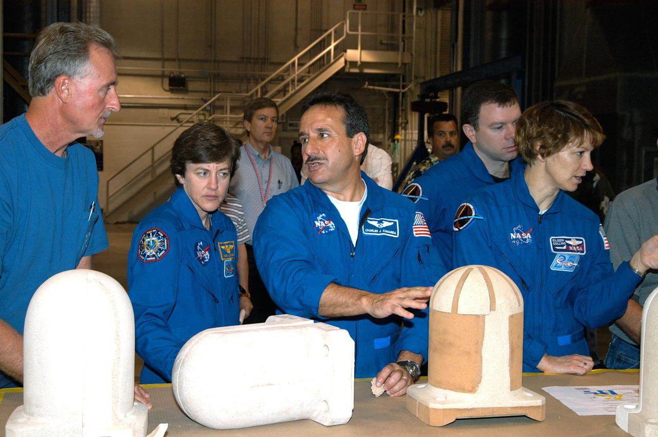 KENNEDY SPACE CENTER, FLA. -  In the SRB Assembly and Refurbishment Facility,  STS-114 crew members look at test designs of the bolt catcher insulation.  Starting second from left are Mission Specialists Wendy Lawrence and Charles Camarda; Pilot James Kelly; and Commander Eileen Collins.  The STS-114 crew is at KSC for familiarization with Shuttle and mission equipment. The mission is Logistics Flight 1, which is scheduled to deliver supplies and equipment, plus the external stowage platform, to the International Space Station.
