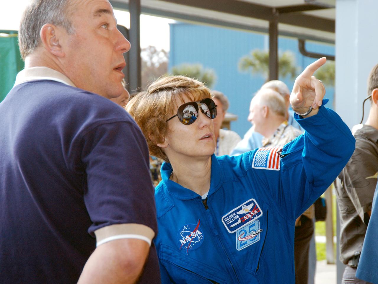 KENNEDY SPACE CENTER, FLA. - At the SRB Assembly and Refurbishment Facility, STS-114 Commander Eileen Collins points to the solid rocket booster aft skirt inside. At left is Bob Herman, SRB deputy associate program manager with United Space Alliance. The STS-114 crew is at KSC for familiarization with Shuttle and mission equipment. The mission is Logistics Flight 1, which is scheduled to deliver supplies and equipment, plus the external stowage platform, to the International Space Station.