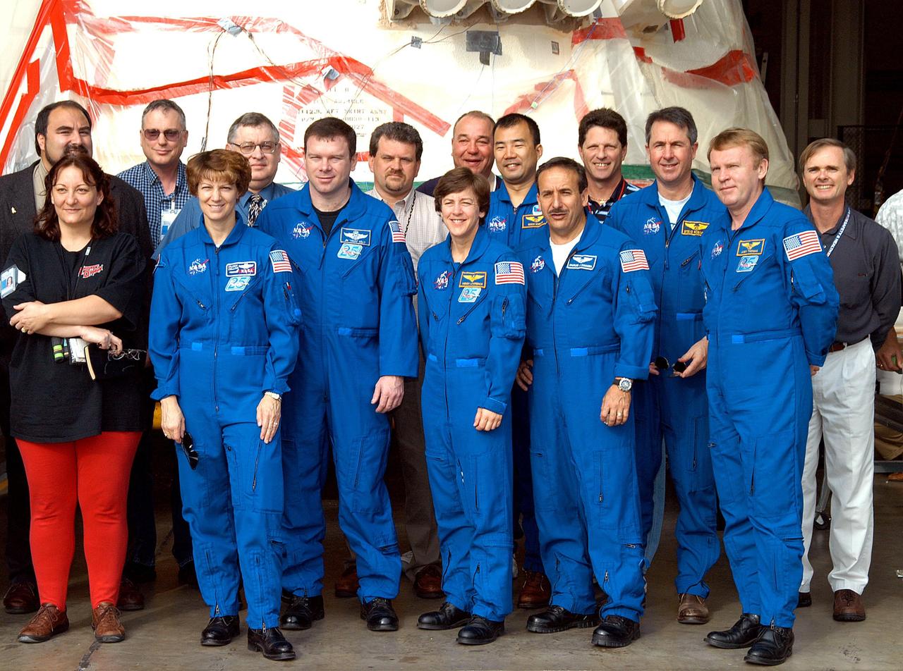 KENNEDY SPACE CENTER, FLA. -  The STS-114 crew pose for a photo in front of a solid rocket booster aft skirt in the SRB Assembly and Refurbishment Facility.  In front, from left, are Cynthia Perrons, electrical technician with United Space Alliance; Commander Eileen Collins, Pilot James Kelly, and Mission Specialists Charles Camarda and Andrew Thomas.  In back are Paul Gutierrez, associate program manager in SRB Element, USA; John Cleary Jr., electrical engineer with USA; Mike Leppert, project lead, Manufacturing Operations, USA; Don Noah, Materials and Processes engineer, USA; Bob Herman, deputy associate program manager, SRB Element, USA; Mission Specialist Soichi Noguchi; Dale Marlow, thermal protection system engineer with USA; Mission Specialist Stephen Robinson; Greg Henry, director, Manufacturing Operations, USA.