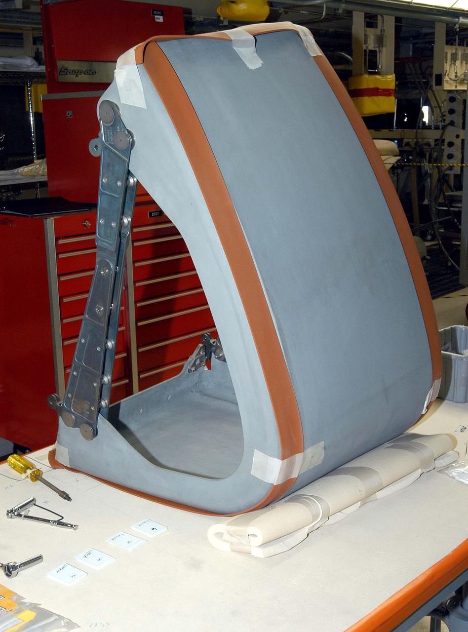 KENNEDY SPACE CENTER, FLA. -  In the Orbiter Processing Facility, the first Reinforced Carbon-Carbon panel is ready for installation on the left wing leading edge on Discovery.  The RCC panels are mechanically attached to the wing with spars, a series of floating joints to reduce loading on the panels caused by wing deflections. Discovery has been named as the orbiter to fly on the first Return to Flight mission, STS-114.