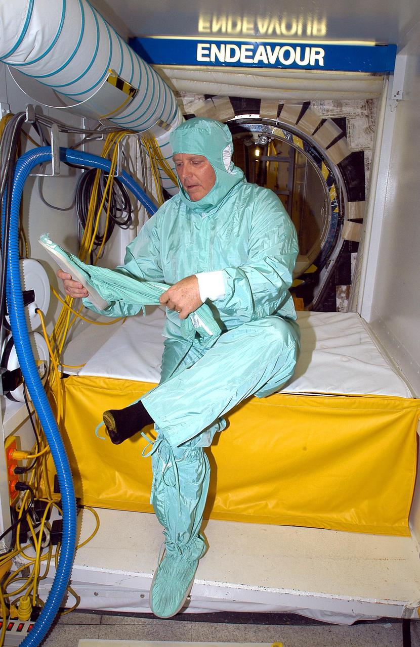 KENNEDY SPACE CENTER, FLA. -  In the Orbiter Processing Facility, Center Director Jim Kennedy is ready to don the final part of the “bunny suit” before entering the orbiter Endeavour, which is in an Orbiter Major Modification period.   Kennedy is taking an opportunity to learn first-hand what workers are doing to enable Return to Flight.