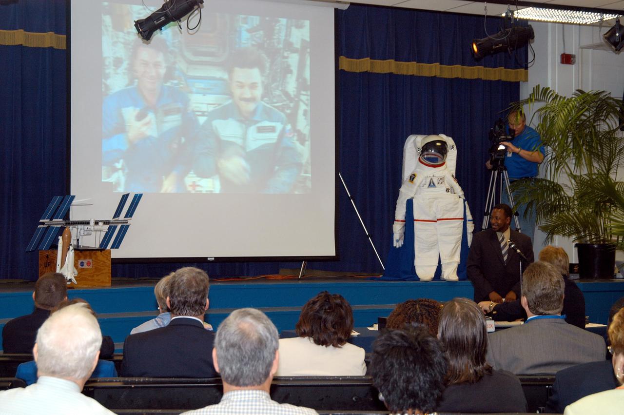 KENNEDY SPACE CENTER, FLA. -  At Howard Bishop Middle School in Gainesville, Fla., during a presentation that shared the new vision for space exploration, the Expedition 8 crew, Commander Michael Foale and Flight Engineer Alexander Kaleri, participated in a downlink from the International Space Station (seen on the screen on stage). Deputy Director Dr. Woodrow Whitlow Jr. represented KSC, talking about our destiny as explorers, NASA’s stepping stone approach to exploring Earth, the Moon, Mars and beyond, how space impacts our lives, and how people and machines rely on each other in space.  Howard Bishop Middle School is one of 50 nationwide (four in Florida) in the NASA Explorer Schools (NES) Program.  NES establishes a three-year partnership between NASA and 50 NASA Explorer Schools teams, consisting of teachers and education administrators from diverse communities nationwide.