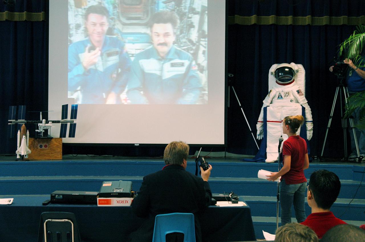 KENNEDY SPACE CENTER, FLA. - At Howard Bishop Middle School in Gainesville, Fla., during a presentation that shared the new vision for space exploration, the Expedition 8 crew, Commander Michael Foale and Flight Engineer Alexander Kaleri, participated in a downlink from the International Space Station (seen on the screen on stage). Deputy Director Dr. Woodrow Whitlow Jr. represented KSC, talking about our destiny as explorers, NASA’s stepping stone approach to exploring Earth, the Moon, Mars and beyond, how space impacts our lives, and how people and machines rely on each other in space. Howard Bishop Middle School is one of 50 nationwide (four in Florida) in the NASA Explorer Schools (NES) Program. NES establishes a three-year partnership between NASA and 50 NASA Explorer Schools teams, consisting of teachers and education administrators from diverse communities nationwide.