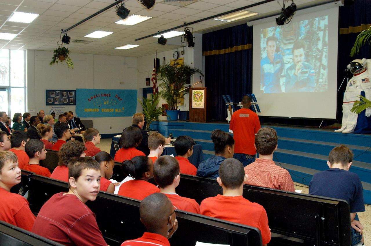 KENNEDY SPACE CENTER, FLA. - At Howard Bishop Middle School in Gainesville, Fla., a student asks the Expedition 8 crew (Commander Michael Foale and Flight Engineer Alexander Kaleri seen on the screen on stage) a question in a downlink from the International Space Station. During a presentation that shared the new vision for space exploration, KSC Deputy Director Dr. Woodrow Whitlow Jr. talked about our destiny as explorers, NASA’s stepping stone approach to exploring Earth, the Moon, Mars and beyond, how space impacts our lives, and how people and machines rely on each other in space. Howard Bishop Middle School is one of 50 nationwide (four in Florida) in the NASA Explorer Schools (NES) Program. NES establishes a three-year partnership between NASA and 50 NASA Explorer Schools teams, consisting of teachers and education administrators from diverse communities nationwide.