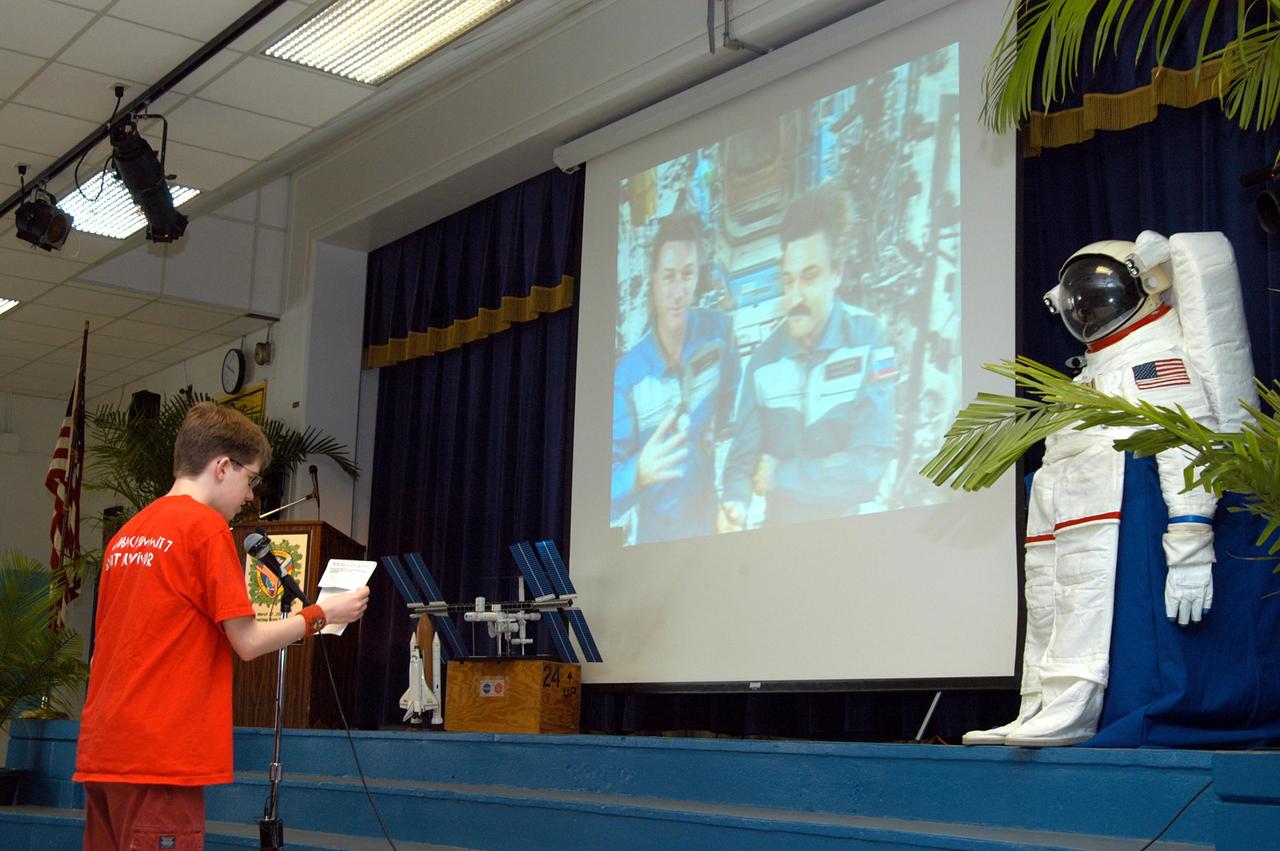 KENNEDY SPACE CENTER, FLA. - At Howard Bishop Middle School in Gainesville, Fla., a student asks the Expedition 8 crew (Commander Michael Foale and Flight Engineer Alexander Kaleri seen on the screen on stage) a question in a downlink from the International Space Station. During a presentation that shared the new vision for space exploration, KSC Deputy Director Dr. Woodrow Whitlow Jr. talked about our destiny as explorers, NASA’s stepping stone approach to exploring Earth, the Moon, Mars and beyond, how space impacts our lives, and how people and machines rely on each other in space. Howard Bishop Middle School is one of 50 nationwide (four in Florida) in the NASA Explorer Schools (NES) Program. NES establishes a three-year partnership between NASA and 50 NASA Explorer Schools teams, consisting of teachers and education administrators from diverse communities nationwide.