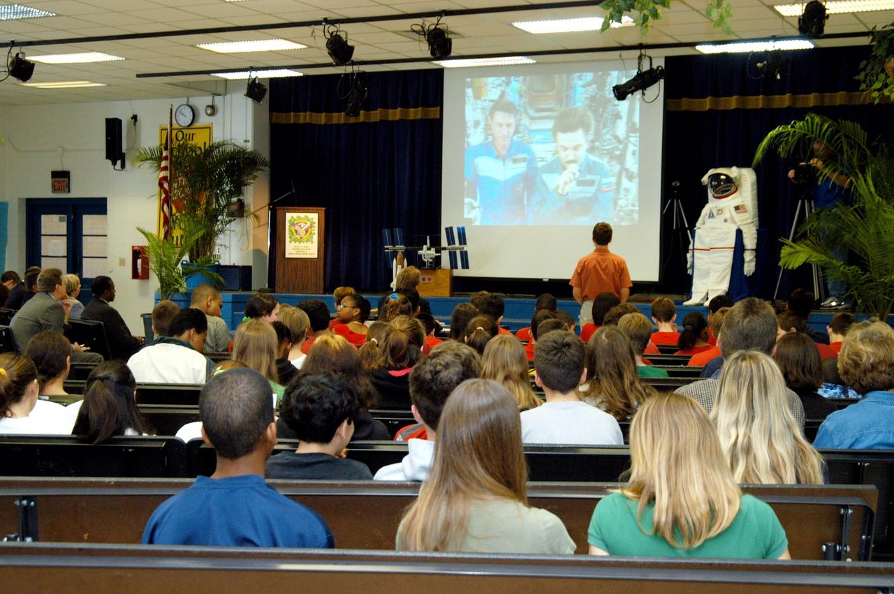 KENNEDY SPACE CENTER, FLA. - At Howard Bishop Middle School in Gainesville, Fla., a student asks the Expedition 8 crew (Commander Michael Foale and Flight Engineer Alexander Kaleri seen on the screen on stage) a question in a downlink from the International Space Station. During a presentation that shared the new vision for space exploration, KSC Deputy Director Dr. Woodrow Whitlow Jr. talked about our destiny as explorers, NASA’s stepping stone approach to exploring Earth, the Moon, Mars and beyond, how space impacts our lives, and how people and machines rely on each other in space. Howard Bishop Middle School is one of 50 nationwide (four in Florida) in the NASA Explorer Schools (NES) Program. NES establishes a three-year partnership between NASA and 50 NASA Explorer Schools teams, consisting of teachers and education administrators from diverse communities nationwide.