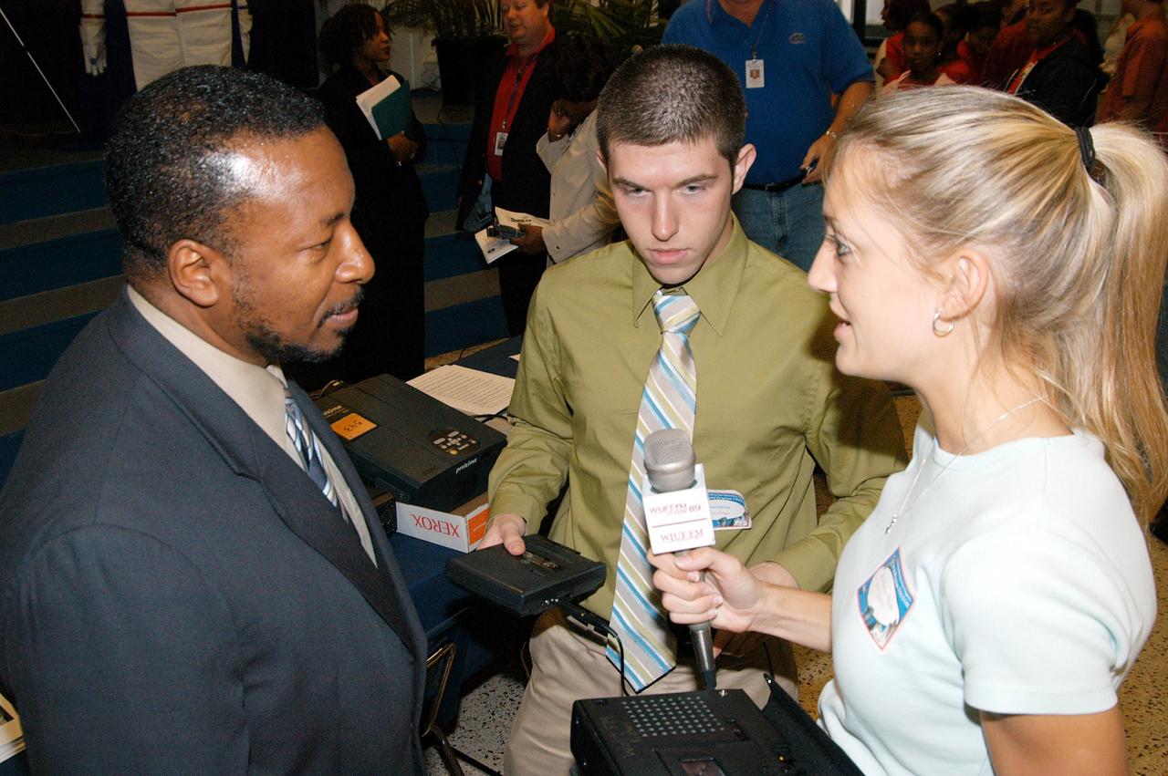 KENNEDY SPACE CENTER, FLA. - KSC Deputy Director Woodrow Whitlow Jr. (left) is interviewed by a reporter (right) for WTUF-FM radio after a presentation at Howard Bishop Middle School in Gainesville, Fla. Dr. Whitlow shared the new vision for space exploration with the students, the next generation of explorers. Whitlow talked about our destiny as explorers, NASA’s stepping stone approach to exploring Earth, the Moon, Mars and beyond, how space impacts our lives, and how people and machines rely on each other in space. The presentation also included a downlink from the International Space Station for students to ask questions of the Expedition 8 crew, Commander Michael Foale and Flight Engineer Alexander Kaleri. Howard Bishop Middle School is one of 50 nationwide (four in Florida) in the NASA Explorer Schools (NES) Program. NES establishes a three-year partnership between NASA and 50 NASA Explorer Schools teams, consisting of teachers and education administrators from diverse communities nationwide.