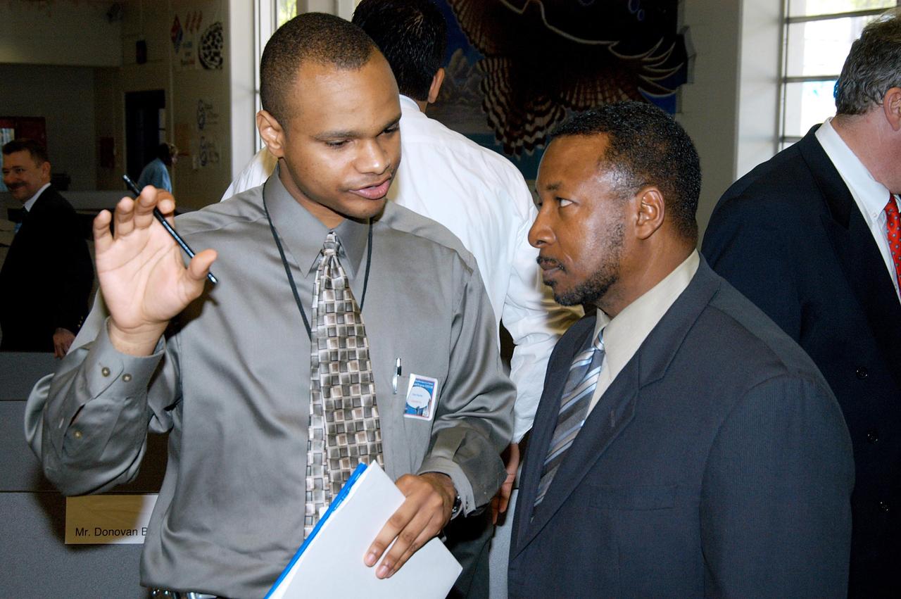 KENNEDY SPACE CENTER, FLA. - KSC Deputy Director Woodrow Whitlow Jr. (right) is interviewed after a presentation at Howard Bishop Middle School in Gainesville, Fla. Dr. Whitlow shared the new vision for space exploration with the students, the next generation of explorers. Whitlow talked about our destiny as explorers, NASA’s stepping stone approach to exploring Earth, the Moon, Mars and beyond, how space impacts our lives, and how people and machines rely on each other in space. The presentation also included a downlink from the International Space Station for students to ask questions of the Expedition 8 crew, Commander Michael Foale and Flight Engineer Alexander Kaleri. Howard Bishop Middle School is one of 50 nationwide (four in Florida) in the NASA Explorer Schools (NES) Program. NES establishes a three-year partnership between NASA and 50 NASA Explorer Schools teams, consisting of teachers and education administrators from diverse communities nationwide.