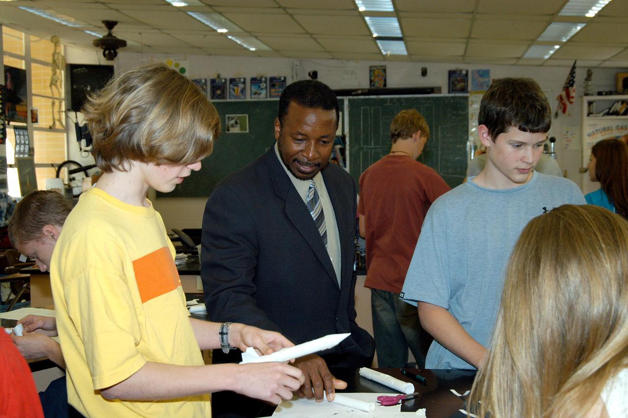 KENNEDY SPACE CENTER, FLA. - KSC Deputy Director Woodrow Whitlow Jr. looks at students’ projects in a classroom at Howard Bishop Middle School in Gainesville, Fla. Dr. Whitlow shared the new vision for space exploration with the students, the next generation of explorers. Whitlow talked about our destiny as explorers, NASA’s stepping stone approach to exploring Earth, the Moon, Mars and beyond, how space impacts our lives, and how people and machines rely on each other in space. The presentation also included a downlink from the International Space Station for students to ask questions of the Expedition 8 crew, Commander Michael Foale and Flight Engineer Alexander Kaleri. Howard Bishop Middle School is one of 50 nationwide (four in Florida) in the NASA Explorer Schools (NES) Program. NES establishes a three-year partnership between NASA and 50 NASA Explorer Schools teams, consisting of teachers and education administrators from diverse communities nationwide.