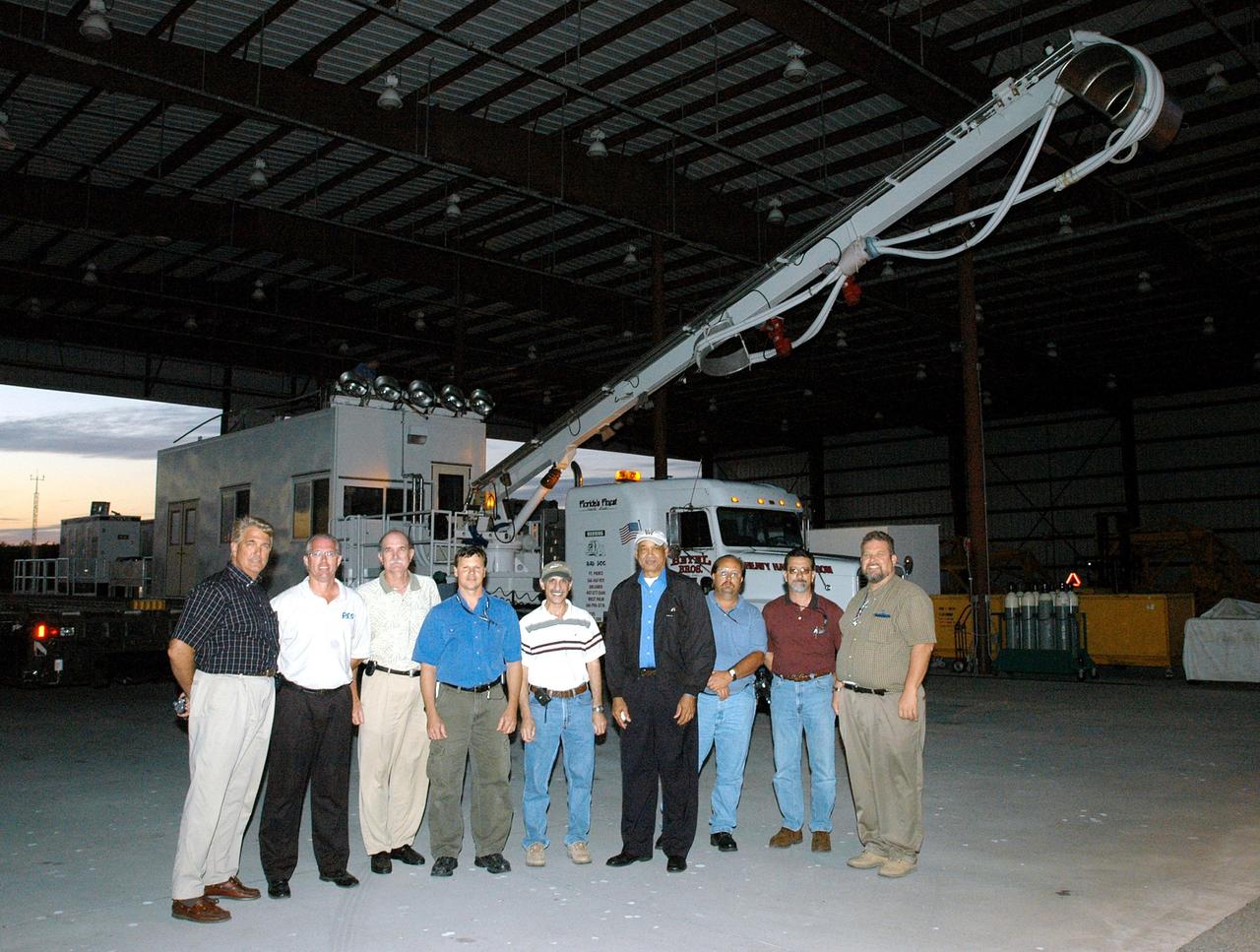 KENNEDY SPACE CENTER, FLA. -  All of the workers involved in the arrival of the Universal Coolant Transporter (UCT), manufactured  in Sharpes, Fla., gather for a photo.  Replacing the existing ground cooling unit, the UCT is designed to service payloads for the Space Shuttle and International Space Station, and may be capable of servicing space exploration vehicles of the future.  It will provide ground cooling to the orbiter and returning payloads, such as science experiments requiring cold or freezing temperatures, during post-landing activities at the SLF and during transport of the payloads to other facilities.