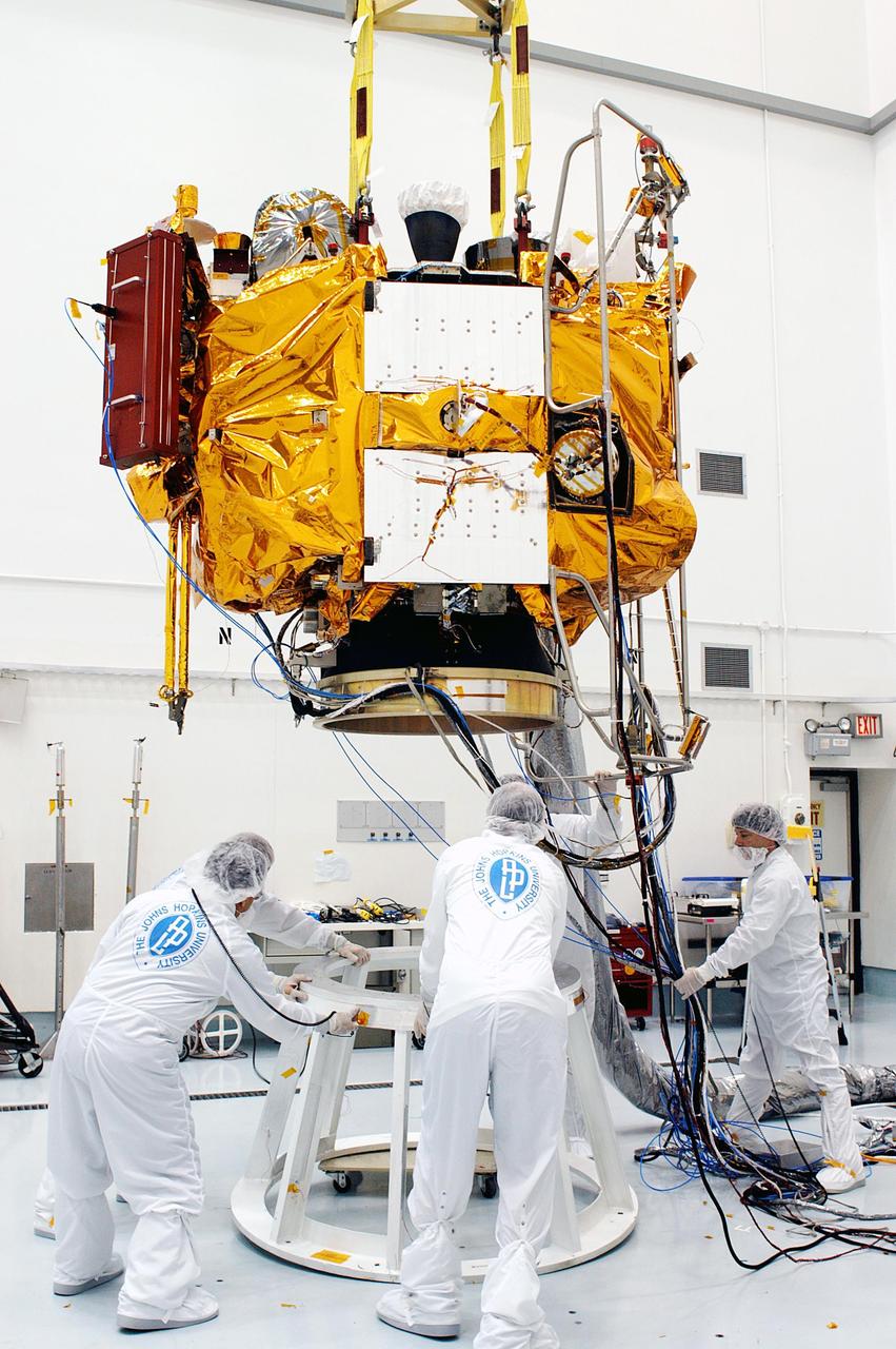 KENNEDY SPACE CENTER, FLA. -- At the Astrotech Space Operations processing facilities, workers lower NASA’s MESSENGER spacecraft onto a test stand using an overhead crane. Once in place, employees of the Johns Hopkins University Applied Physics Laboratory, builders of the spacecraft, will begin final processing for launch, including checkout of the power systems, communications systems and control systems. The thermal blankets will also be attached for flight. MESSENGER - short for MErcury Surface, Space ENvironment, GEochemistry and Ranging - will be launched aboard a Boeing Delta II rocket no earlier than July 30 on a six-year mission to study the planet Mercury.