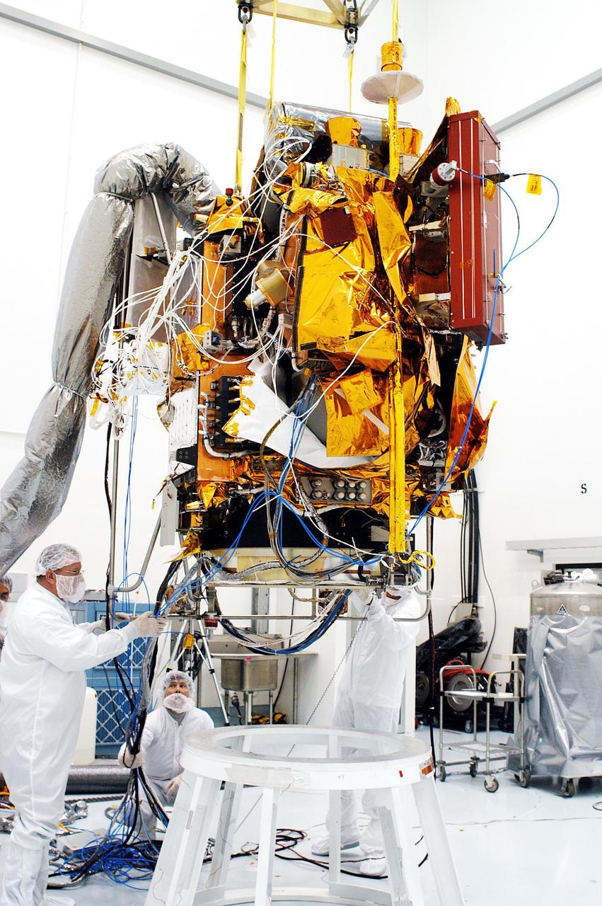 KENNEDY SPACE CENTER, FLA. -- At the Astrotech Space Operations processing facilities, workers monitor NASA’s MESSENGER spacecraft as it is lowered onto a test stand by an overhead crane. Once in place, employees of the Johns Hopkins University Applied Physics Laboratory, builders of the spacecraft, will begin final processing for launch, including checkout of the power systems, communications systems and control systems. The thermal blankets will also be attached for flight. MESSENGER - short for MErcury Surface, Space ENvironment, GEochemistry and Ranging - will be launched aboard a Boeing Delta II rocket no earlier than July 30 on a six-year mission to study the planet Mercury.