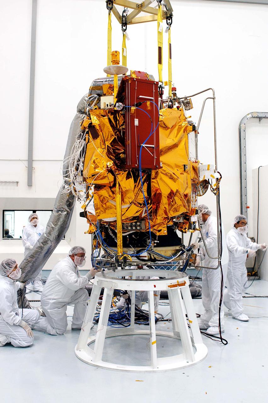 KENNEDY SPACE CENTER, FLA. -- At the Astrotech Space Operations processing facilities, workers prepare for contact of NASA’s MESSENGER spacecraft with a test stand. Once in place, employees of the Johns Hopkins University Applied Physics Laboratory, builders of the spacecraft, will begin final processing for launch, including checkout of the power systems, communications systems and control systems. The thermal blankets will also be attached for flight. MESSENGER - short for MErcury Surface, Space ENvironment, GEochemistry and Ranging - will be launched aboard a Boeing Delta II rocket no earlier than July 30 on a six-year mission to study the planet Mercury.