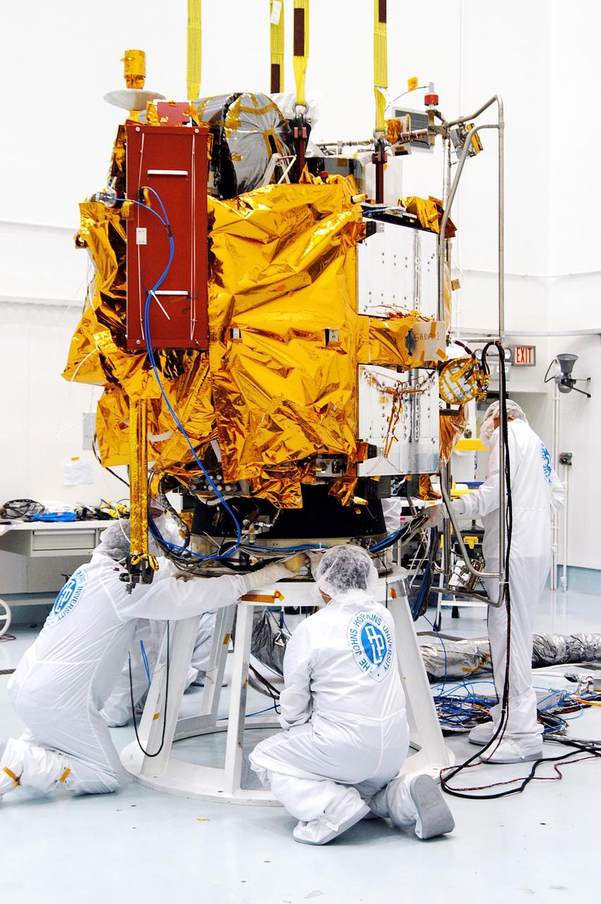 KENNEDY SPACE CENTER, FLA. -- At the Astrotech Space Operations processing facilities, workers verify the correct placement of NASA’s MESSENGER spacecraft on a test stand. Once in place, employees of the Johns Hopkins University Applied Physics Laboratory, builders of the spacecraft, will begin final processing for launch, including checkout of the power systems, communications systems and control systems. The thermal blankets will also be attached for flight. MESSENGER - short for MErcury Surface, Space ENvironment, GEochemistry and Ranging - will be launched aboard a Boeing Delta II rocket no earlier than July 30 on a six-year mission to study the planet Mercury.