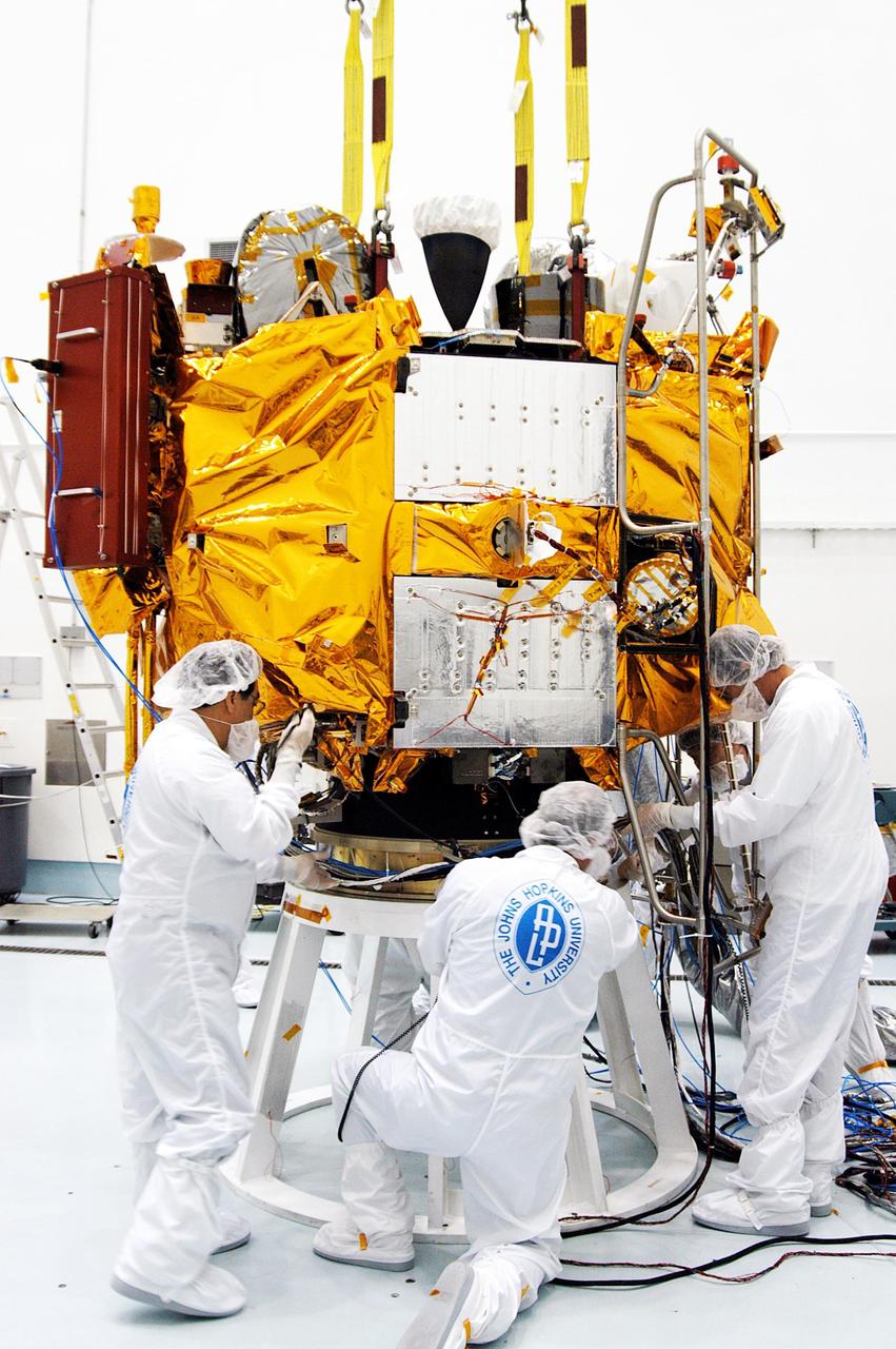 KENNEDY SPACE CENTER, FLA. -- At the Astrotech Space Operations processing facilities, workers secure NASA’s MESSENGER spacecraft on a test stand. Once in place, employees of the Johns Hopkins University Applied Physics Laboratory, builders of the spacecraft, will begin final processing for launch, including checkout of the power systems, communications systems and control systems. The thermal blankets will also be attached for flight. MESSENGER - short for MErcury Surface, Space ENvironment, GEochemistry and Ranging - will be launched aboard a Boeing Delta II rocket no earlier than July 30 on a six-year mission to study the planet Mercury.