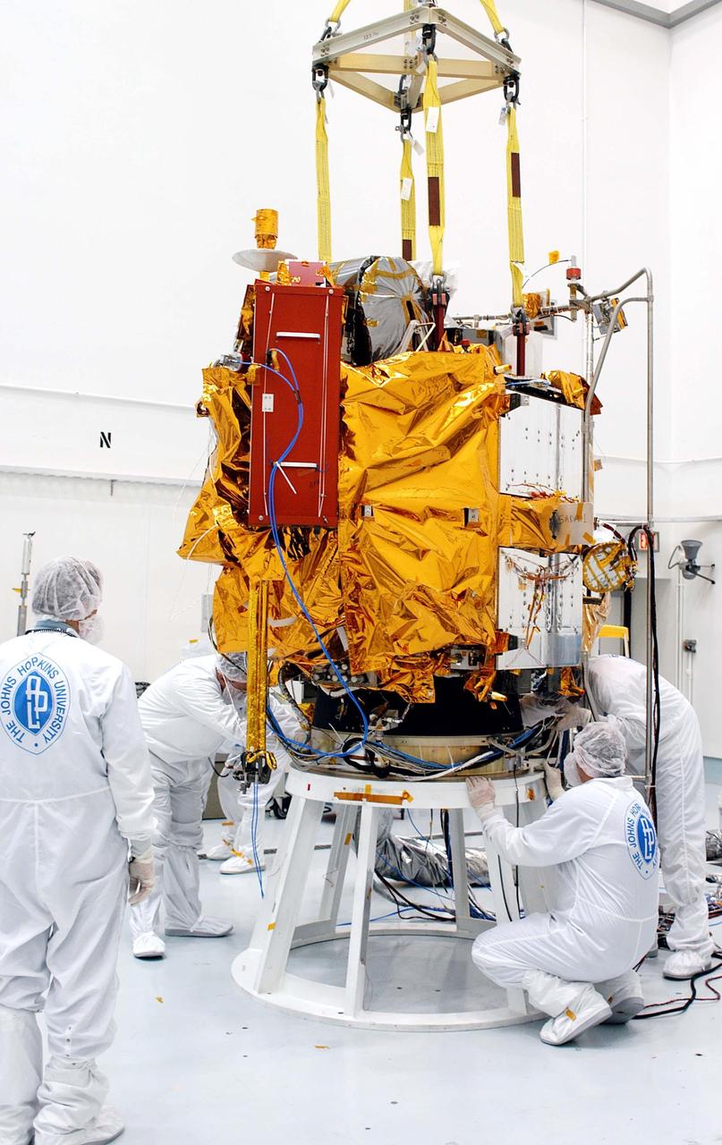 KENNEDY SPACE CENTER, FLA. -- At the Astrotech Space Operations processing facilities, workers secure NASA’s MESSENGER spacecraft on a test stand. Once in place, employees of the Johns Hopkins University Applied Physics Laboratory, builders of the spacecraft, will begin final processing for launch, including checkout of the power systems, communications systems and control systems. The thermal blankets will also be attached for flight. MESSENGER - short for MErcury Surface, Space ENvironment, GEochemistry and Ranging - will be launched aboard a Boeing Delta II rocket no earlier than July 30 on a six-year mission to study the planet Mercury.