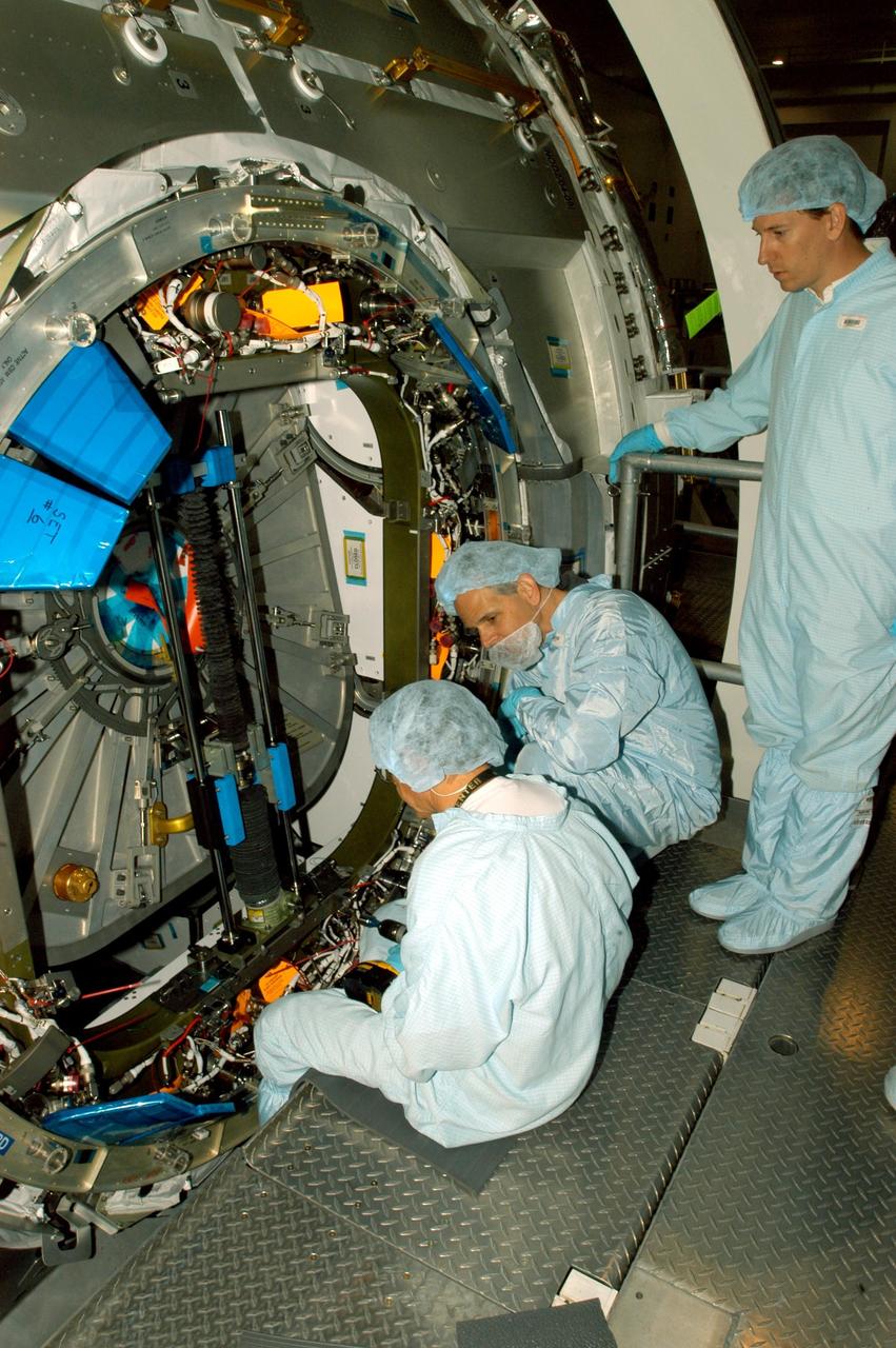 KENNEDY SPACE CENTER, FLA. -- In the Space Station Processing Facility, with the help of a lifting device, the starboard hatch is lifted on the Node 2 module.  The second of three Station connecting modules, the Node 2 attaches to the end of the U.S. Lab and provides attach locations for several other elements.  Node 2 is scheduled to launch on mission STS-120, Station assembly flight 10A.