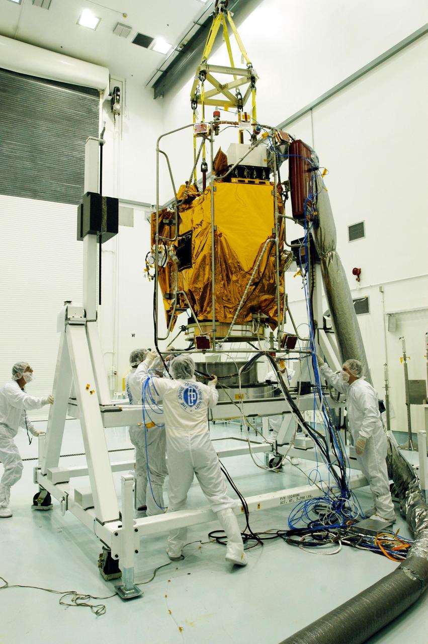 KENNEDY SPACE CENTER, FLA. -- At Astrotech Space Operations facilities near KSC, workers help while an overhead crane lowers the Mercury Surface, Space Environment, Geochemistry and Ranging (MESSENGER) spacecraft onto a turnover fixture. Workers will perform the propulsion system phasing test - firing gas through the thrusters in order to verify that the right thrusters fire when expected - as part of prelaunch testing at the site. Launch is scheduled for May 11 from Pad 17-B, Cape Canaveral Air Force Station. The spacecraft will fly past Venus three times and Mercury twice before starting a year-long orbital study of Mercury in July 2009.