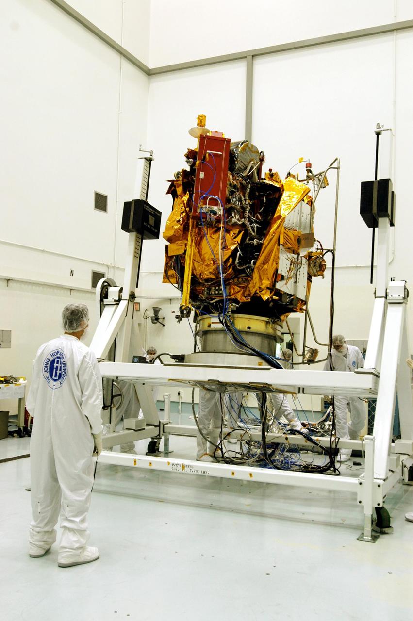 KENNEDY SPACE CENTER, FLA. -- Astrotech Space Operations facilities near KSC, workers begin to rotate the Mercury Surface, Space Environment, Geochemistry and Ranging (MESSENGER) spacecraft on the turnover fixture. Workers will perform the propulsion system phasing test - firing gas through the thrusters in order to verify that the right thrusters fire when expected - as part of prelaunch testing at the site. Launch is scheduled for May 11 from Pad 17-B, Cape Canaveral Air Force Station. The spacecraft will fly past Venus three times and Mercury twice before starting a year-long orbital study of Mercury in July 2009.