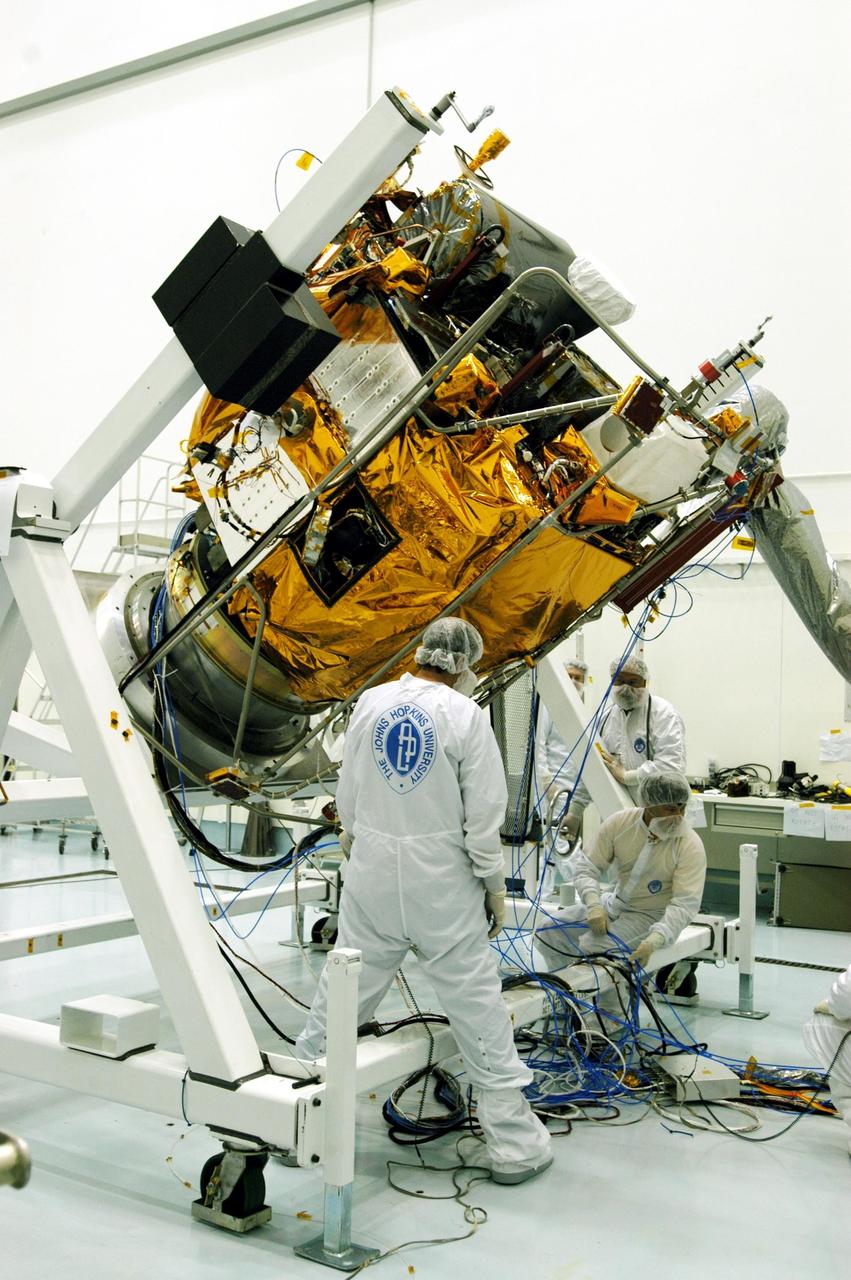 KENNEDY SPACE CENTER, FLA. -- Astrotech Space Operations facilities near KSC, workers begin to rotate the Mercury Surface, Space Environment, Geochemistry and Ranging (MESSENGER) spacecraft on the turnover fixture. Workers will perform the propulsion system phasing test - firing gas through the thrusters in order to verify that the right thrusters fire when expected - as part of prelaunch testing at the site. Launch is scheduled for May 11 from Pad 17-B, Cape Canaveral Air Force Station. The spacecraft will fly past Venus three times and Mercury twice before starting a year-long orbital study of Mercury in July 2009.