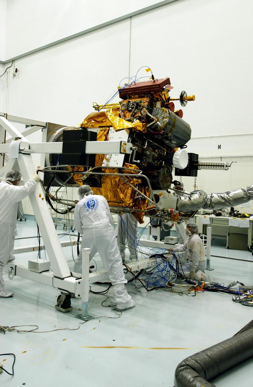 KENNEDY SPACE CENTER, FLA. -- - Astrotech Space Operations facilities near KSC, workers check the Mercury Surface, Space Environment, Geochemistry and Ranging (MESSENGER) spacecraft as it rotates on the turnover fixture. Workers will perform the propulsion system phasing test - firing gas through the thrusters in order to verify that the right thrusters fire when expected - as part of prelaunch testing at the site. Launch is scheduled for May 11 from Pad 17-B, Cape Canaveral Air Force Station. The spacecraft will fly past Venus three times and Mercury twice before starting a year-long orbital study of Mercury in July 2009.