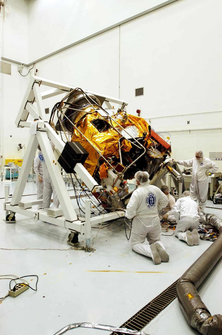 KENNEDY SPACE CENTER, FLA. -- Astrotech Space Operations facilities near KSC, workers again rotate the Mercury Surface, Space Environment, Geochemistry and Ranging (MESSENGER) spacecraft on the turnover fixture. Workers will perform the propulsion system phasing test - firing gas through the thrusters in order to verify that the right thrusters fire when expected - as part of prelaunch testing at the site. Launch is scheduled for May 11 from Pad 17-B, Cape Canaveral Air Force Station. The spacecraft will fly past Venus three times and Mercury twice before starting a year-long orbital study of Mercury in July 2009.