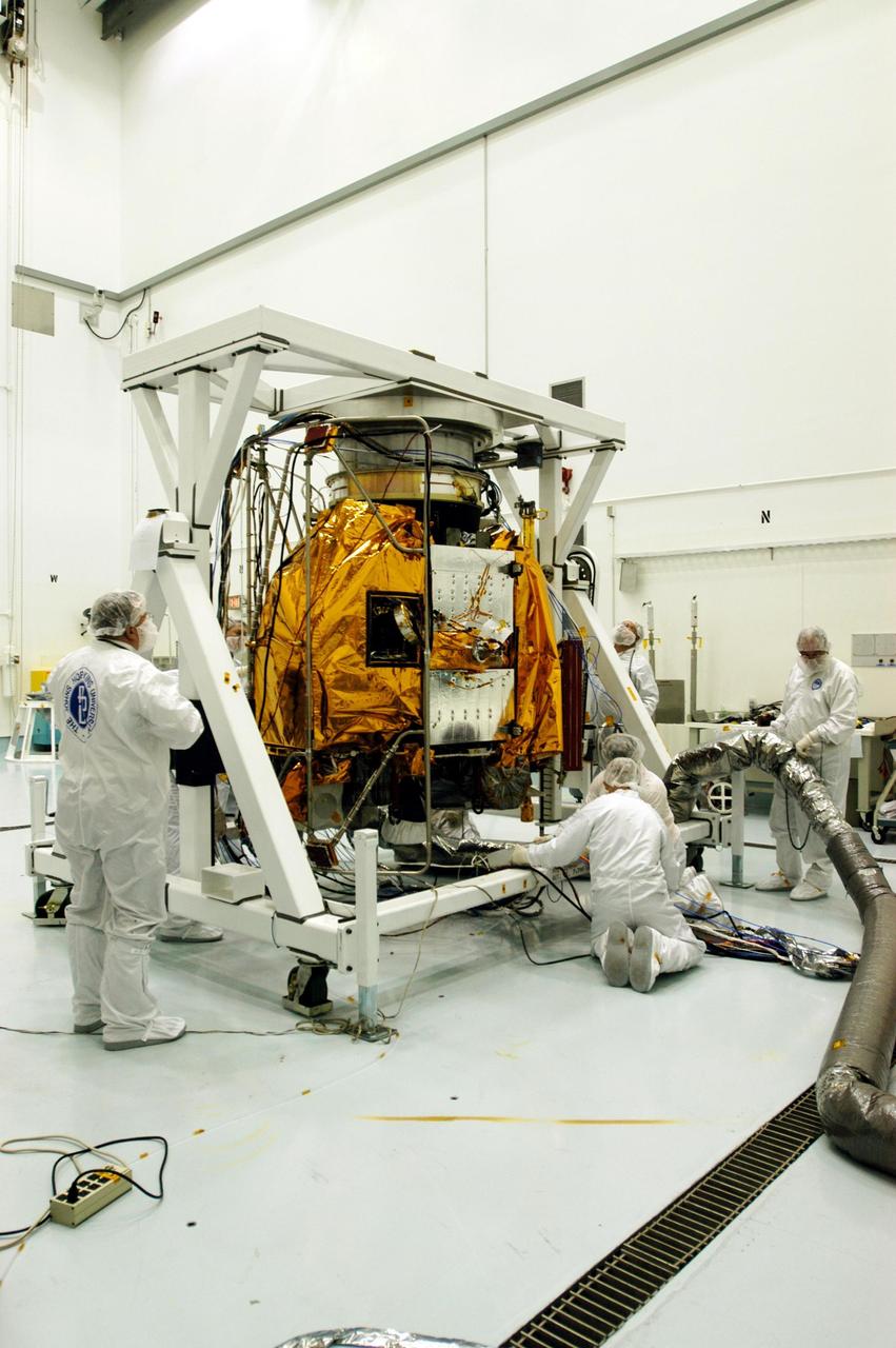 KENNEDY SPACE CENTER, FLA. -- Astrotech Space Operations facilities near KSC, workers complete rotation of the Mercury Surface, Space Environment, Geochemistry and Ranging (MESSENGER) spacecraft on the turnover fixture. Workers will perform the propulsion system phasing test - firing gas through the thrusters in order to verify that the right thrusters fire when expected - as part of prelaunch testing at the site. Launch is scheduled for May 11 from Pad 17-B, Cape Canaveral Air Force Station. The spacecraft will fly past Venus three times and Mercury twice before starting a year-long orbital study of Mercury in July 2009.
