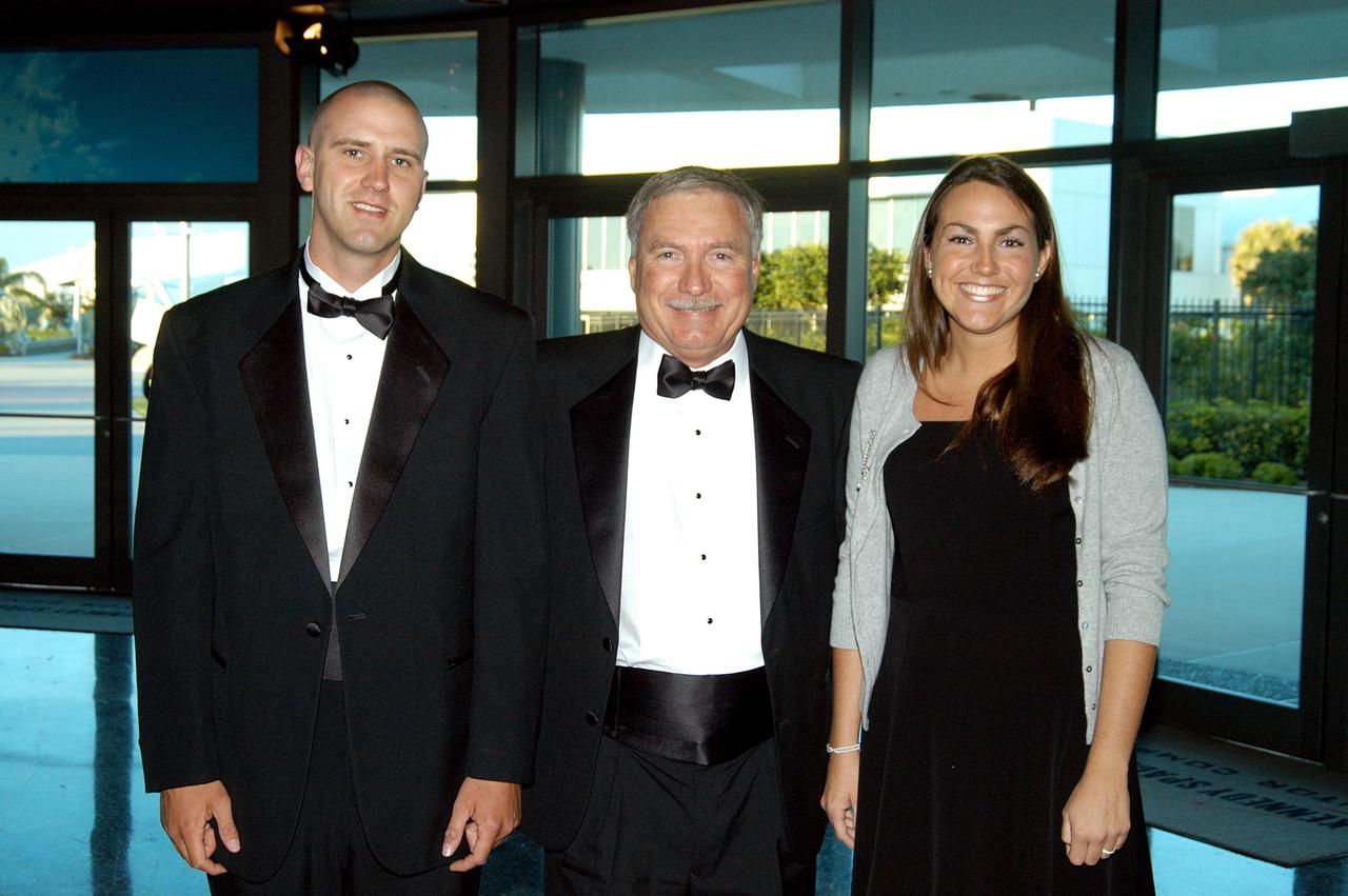KENNEDY SPACE CENTER, FLA. -- John J. “Tip” Talone (center) poses with his son and daughter during the annual National Space Club Debus Award Banquet. Talone received the award that was created to recognize significant achievements made in Florida to American aerospace efforts. The event was held at the Dr. Kurt H. Debus Conference Facility in the Visitor Complex. Talone is director of the International Space Station/Payloads Processing directorate at KSC that is responsible for prelaunch and launch preparations for all Shuttle payloads. He was honored for his outstanding personal and professional efforts in supporting the U.S. space program, especially in his current role. The award was created by the National Space Club Florida Committee to recognize significant achievements and contributions made in Florida to American aerospace efforts. It is named for Dr. Kurt H. Debus, first director of KSC, from 1962 to 1974.