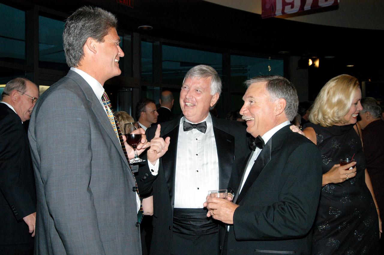 KENNEDY SPACE CENTER, FLA. -- John J. “Tip” Talone (right) shares a bit of humor with Shuttle Program Manager Bill Parsons (left) and Center Director Jim Kennedy during the annual National Space Club Debus Award Banquet. Talone received the award that was created by the National Space Club to recognize significant achievements made in Florida to American aerospace efforts. The event was held at the Dr. Kurt H. Debus Conference Facility in the Visitor Complex. Talone is director of the International Space Station/Payloads Processing directorate at KSC that is responsible for prelaunch and launch preparations for all Shuttle payloads. He was honored for his outstanding personal and professional efforts in supporting the U.S. space program, especially in his current role. The award was created by the National Space Club Florida Committee to recognize significant achievements and contributions made in Florida to American aerospace efforts. It is named for Dr. Kurt H. Debus, first director of KSC, from 1962 to 1974.