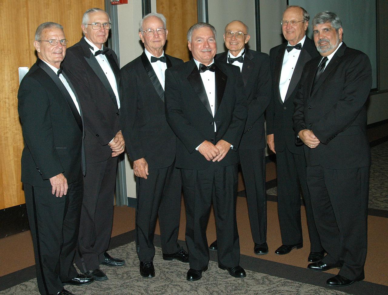 KENNEDY SPACE CENTER, FLA. -- Past recipients of the Debus Award join the 2004 awardee John J. “Tip” Talone (center) at the annual National Space Club Debus Award Banquet, held at the Dr. Kurt H. Debus Conference Facility in the KSC Visitor Complex. From left are Forrest McCartney, Lee Solid, Maxwell King, Talone, Bob Sieck, Ernie Briel and Adrian Laffitte. Director of the International Space Station/Payloads Processing directorate, Talone received the award in recognition of his outstanding personal and professional efforts in supporting the U.S. space program, especially in his current role. The award was created by the National Space Club Florida Committee to recognize significant achievements and contributions made in Florida to American aerospace efforts. It is named for Dr. Kurt H. Debus, first director of KSC, from 1962 to 1974.