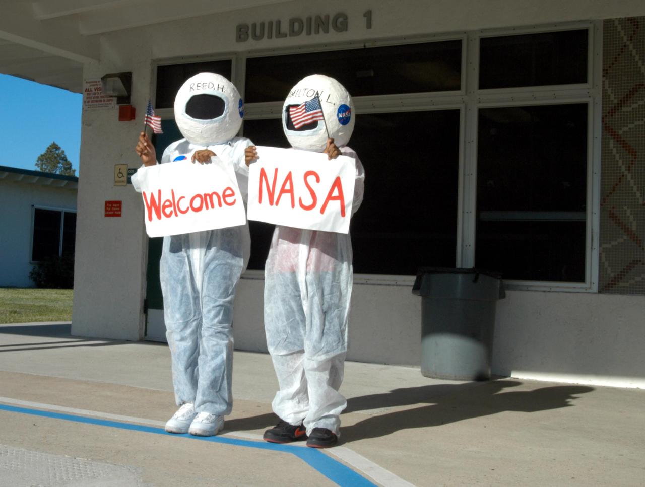 KENNEDY SPACE CENTER, FLA. -- Two student “astronauts” welcome special NASA guests to Oscar Patterson Elementary Magnet School in Panama City, Fla.  Center Director Jim Kennedy made the trip with NASA astronaut Sam Durrance and other NASA-KSC representatives to share America’s new vision  for space exploration with the next generation of explorers. Kennedy is talking with students about our destiny as explorers, NASA’s stepping stone approach to exploring Earth, the Moon, Mars and beyond, how space impacts our lives, and how people and machines rely on each other in space.