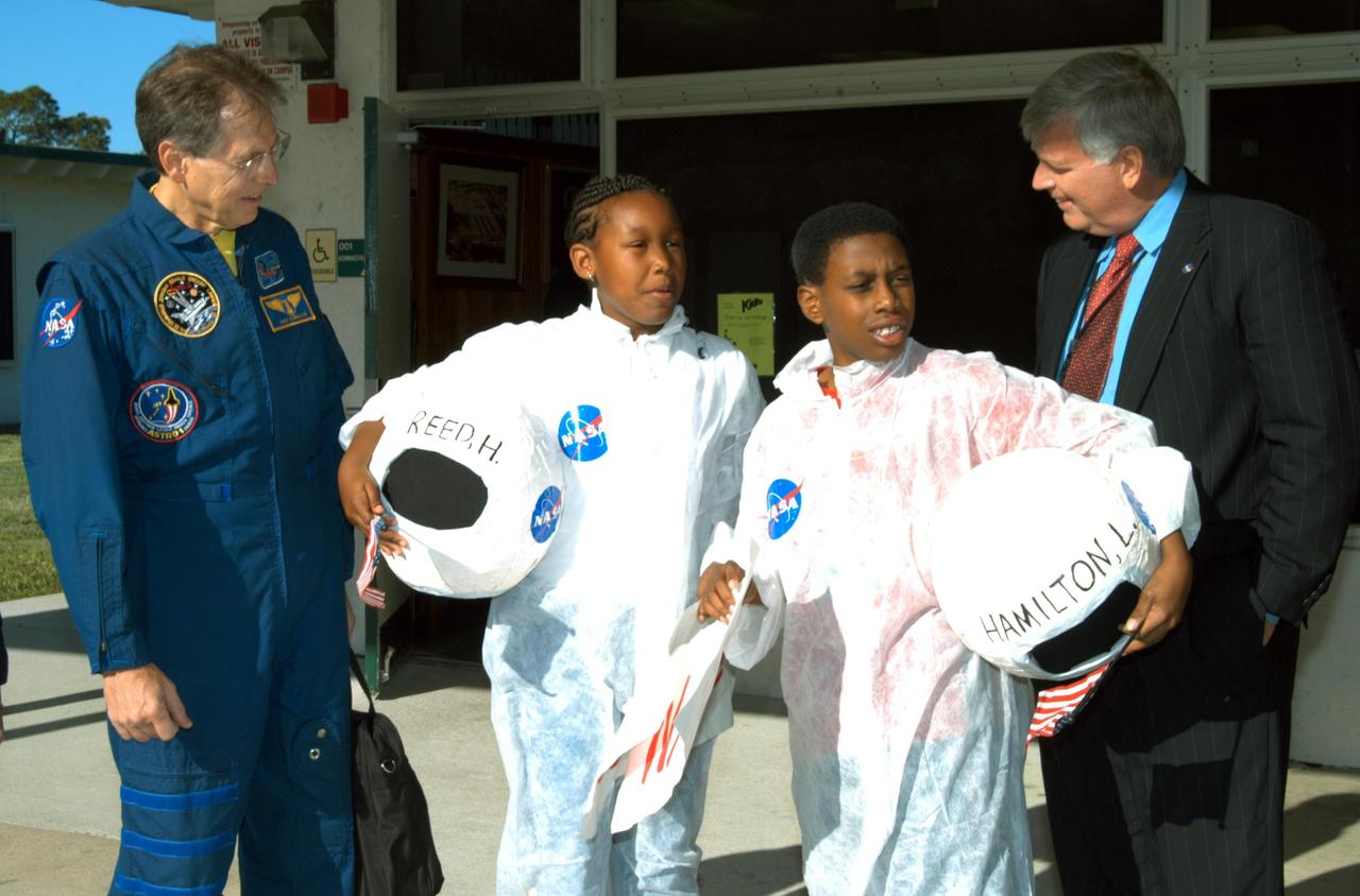 KENNEDY SPACE CENTER, FLA. -- Astronaut Sam Durrance (left) and Center Director Jim Kennedy (right) talk to the two students who greeted their arrival at Oscar Patterson Elementary Magnet School in Panama City, Fla.  Kennedy and other NASA-KSC officials are visiting NASA Explorer Schools in Florida and Georgia to share America’s new vision for space exploration with the next generation of explorers. Kennedy is talking with students about our destiny as explorers, NASA’s stepping stone approach to exploring Earth, the Moon, Mars and beyond, how space impacts our lives, and how people and machines rely on each other in space.