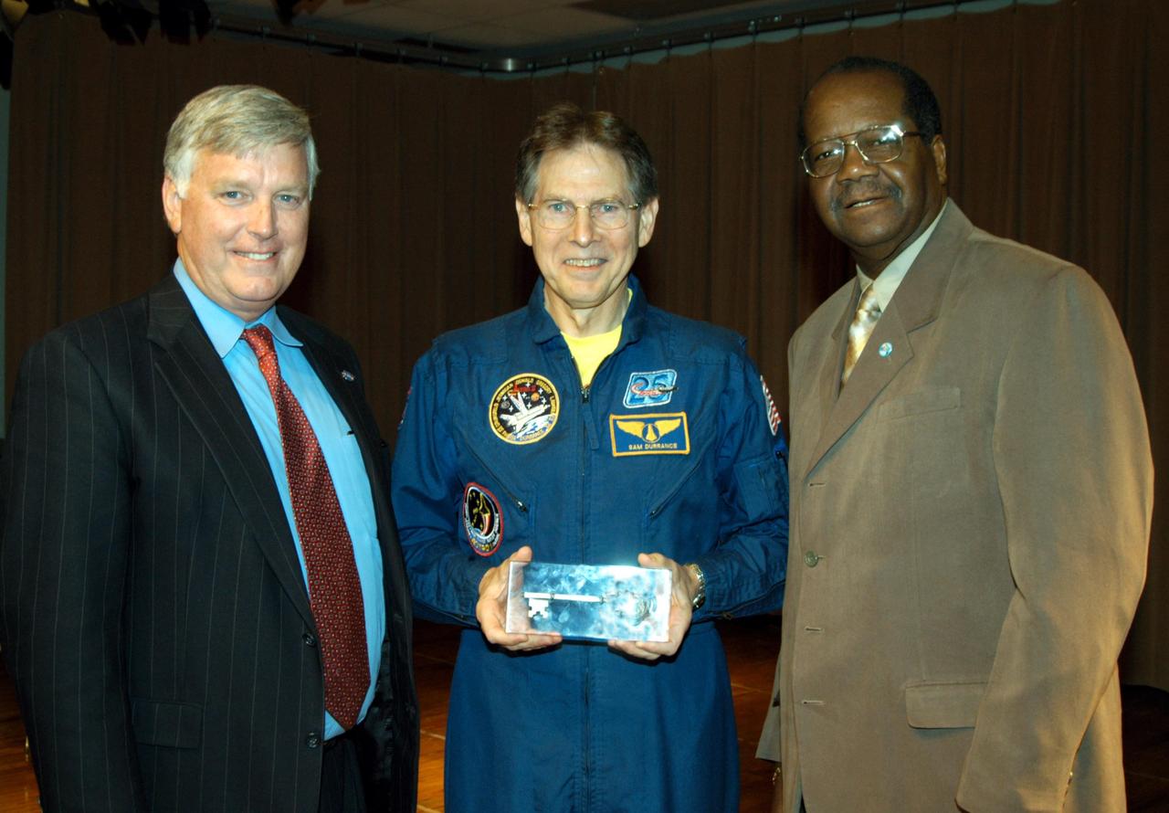 KENNEDY SPACE CENTER, FLA. -- Center Director Jim Kennedy stands with astronaut Sam Durrance, who displays the key to the city presented by Johnathon Wilson, Panama City commissioner (right).  Kennedy and Durrance and other NASA officials were at Oscar Patterson Elementary Magnet School in Panama City, Fla.  They are visiting NASA Explorer Schools in  Florida and Georgia to share America’s new vision for space exploration with the next generation of explorers. Kennedy is talking with students about our destiny as explorers, NASA’s stepping stone approach to exploring Earth, the Moon, Mars and beyond, how space impacts our lives, and how people and machines rely on each other in space.