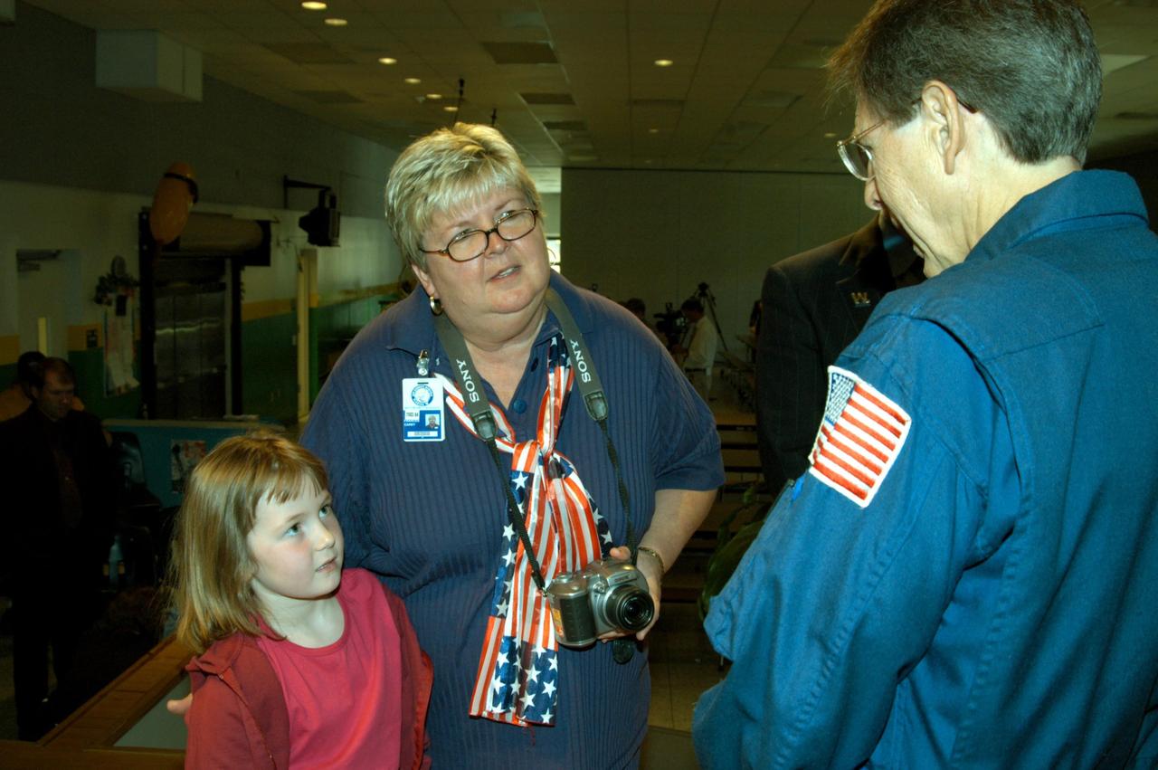 KENNEDY SPACE CENTER, FLA. -- Astronaut Sam Durrance (right) talks to a student and teacher at Oscar Patterson Elementary Magnet School in Panama City, Fla.  He and Center Director Jim Kennedy, along with other NASA representatives, visited the school to share America’s new vision for space exploration with the next generation of explorers. Kennedy is talking with students about our destiny as explorers, NASA’s stepping stone approach to exploring Earth, the Moon, Mars and beyond, how space impacts our lives, and how people and machines rely on each other in space.