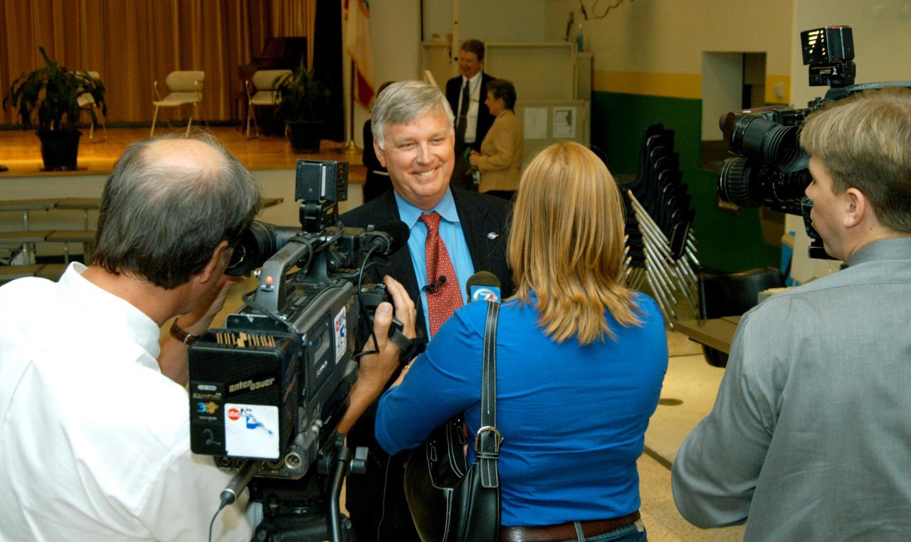 KENNEDY SPACE CENTER, FLA. -- Center Director Jim Kennedy (center) is interviewed by a reporter from channel 7 ABC-TV after his visit to Oscar Patterson Elementary Magnet School in Panama City, Fla.  He other NASA officials visited the school to share America’s new vision  for space exploration with the next generation of explorers. Kennedy is talking with students at NASA Explorer Schools in Florida and Georgia about our destiny as explorers, NASA’s stepping stone approach to exploring Earth, the Moon, Mars and beyond, how space impacts our lives, and how people and machines rely on each other in space.