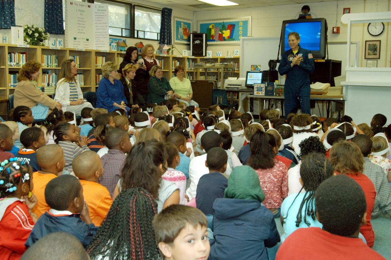 KENNEDY SPACE CENTER, FLA. -- Sam Durrance (standing, in the background) shares stories of his experiences as an astronaut with the students in a classroom at Oscar Patterson Elementary Magnet School in Panama City, Fla.  Durrance joined Center Director Jim Kennedy as he shares America’s new vision  for space exploration with the next generation of explorers.  Kennedy is talking with students at NASA Explorer Schools in Florida and Georgia about our destiny as explorers, NASA’s stepping stone approach to exploring Earth, the Moon, Mars and beyond, how space impacts our lives, and how people and machines rely on each other in space.