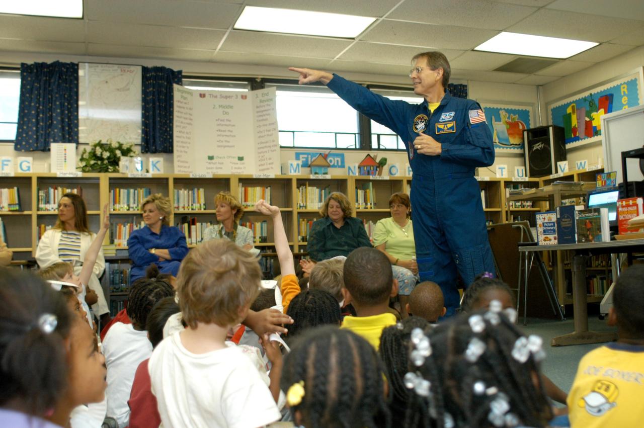 KENNEDY SPACE CENTER, FLA. -- Astronaut Sam Durrance points to a student with a question in a classroom at Oscar Patterson Elementary Magnet School in Panama City, Fla. Sharing stories of his experiences as an astronaut, Durrance joined Center Director Jim Kennedy, who is visiting  Florida and Georgia NASA Explorer Schools to share America’s new vision  for space exploration with the next generation of explorers.  Kennedy is talking with students about our destiny as explorers, NASA’s stepping stone approach to exploring Earth, the Moon, Mars and beyond, how space impacts our lives, and how people and machines rely on each other in space.