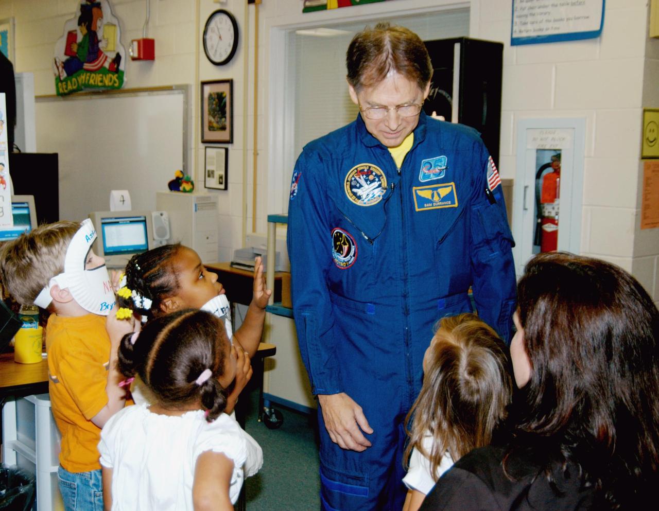 KENNEDY SPACE CENTER, FLA. -- Astronaut Sam Durrance talks to students in a classroom at Oscar Patterson Elementary Magnet School in Panama City, Fla.  Durrance joined Center Director Jim Kennedy, who is visiting  Florida and Georgia NASA Explorer Schools to share America’s new vision  for space exploration with the next generation of explorers.  Kennedy is talking with students about our destiny as explorers, NASA’s stepping stone approach to exploring Earth, the Moon, Mars and beyond, how space impacts our lives, and how people and machines rely on each other in space.