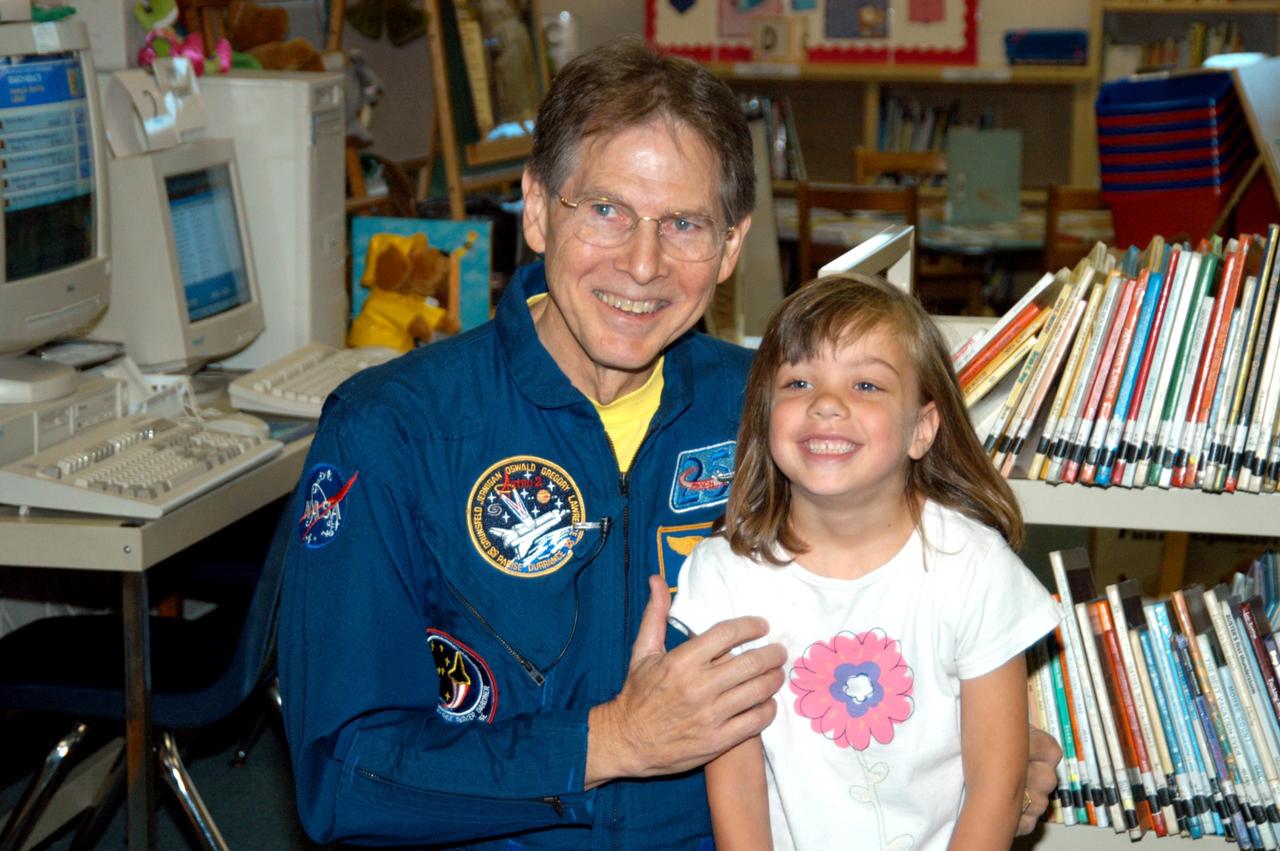 KENNEDY SPACE CENTER, FLA. -- Astronaut Sam Durrance poses with a student from Panama City, Fla., Oscar Patterson Elementary Magnet School.  Durrance joined Center Director Jim Kennedy, who is visiting  Florida and Georgia NASA Explorer Schools to share America’s new vision  for space exploration with the next generation of explorers.  Kennedy is talking with students about our destiny as explorers, NASA’s stepping stone approach to exploring Earth, the Moon, Mars and beyond, how space impacts our lives, and how people and machines rely on each other in space.